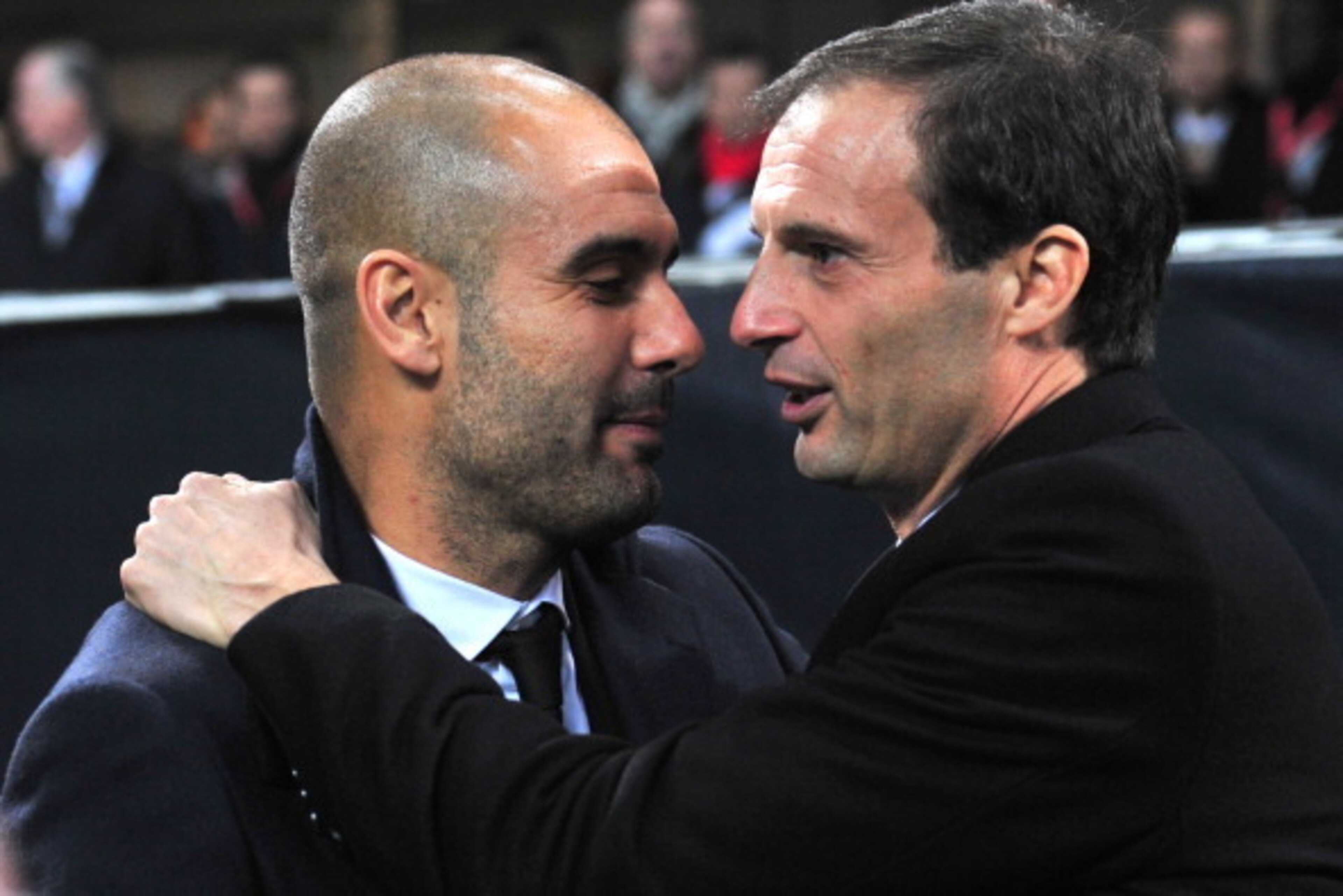 Barcelona's coach Josep Guardiola (L) and AC Milan's coach Massimiliano Allegri hug before the Champions League group H football match AC Milan vs FC Barcelona on November 23, 2011 at San Siro stadium in Milan.  AFP PHOTO / GIUSEPPE CACACE (Photo credit s