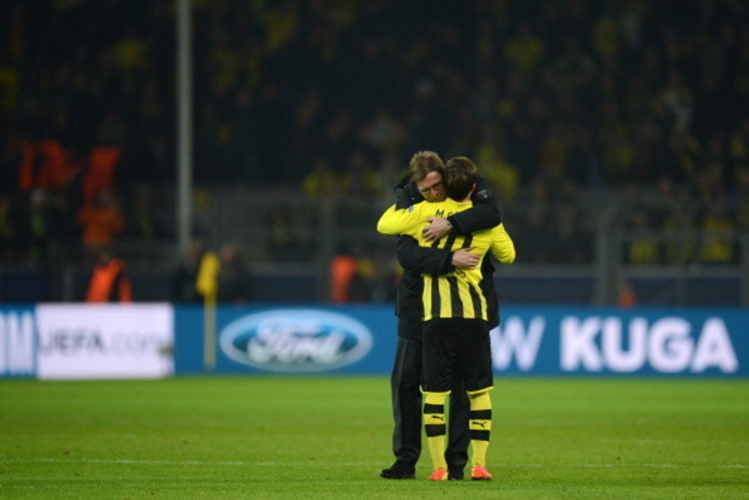 Dortmund's head coach Juergen Klopp (L) and Dortmund's midfielder Mario Goetze celebrate after the UEFA Champions League last 16, second leg match Borussia Dortmund vs Shakhtar Donetsk in Dortmund, western Germany, on March 5, 2013. Dortmund won the match