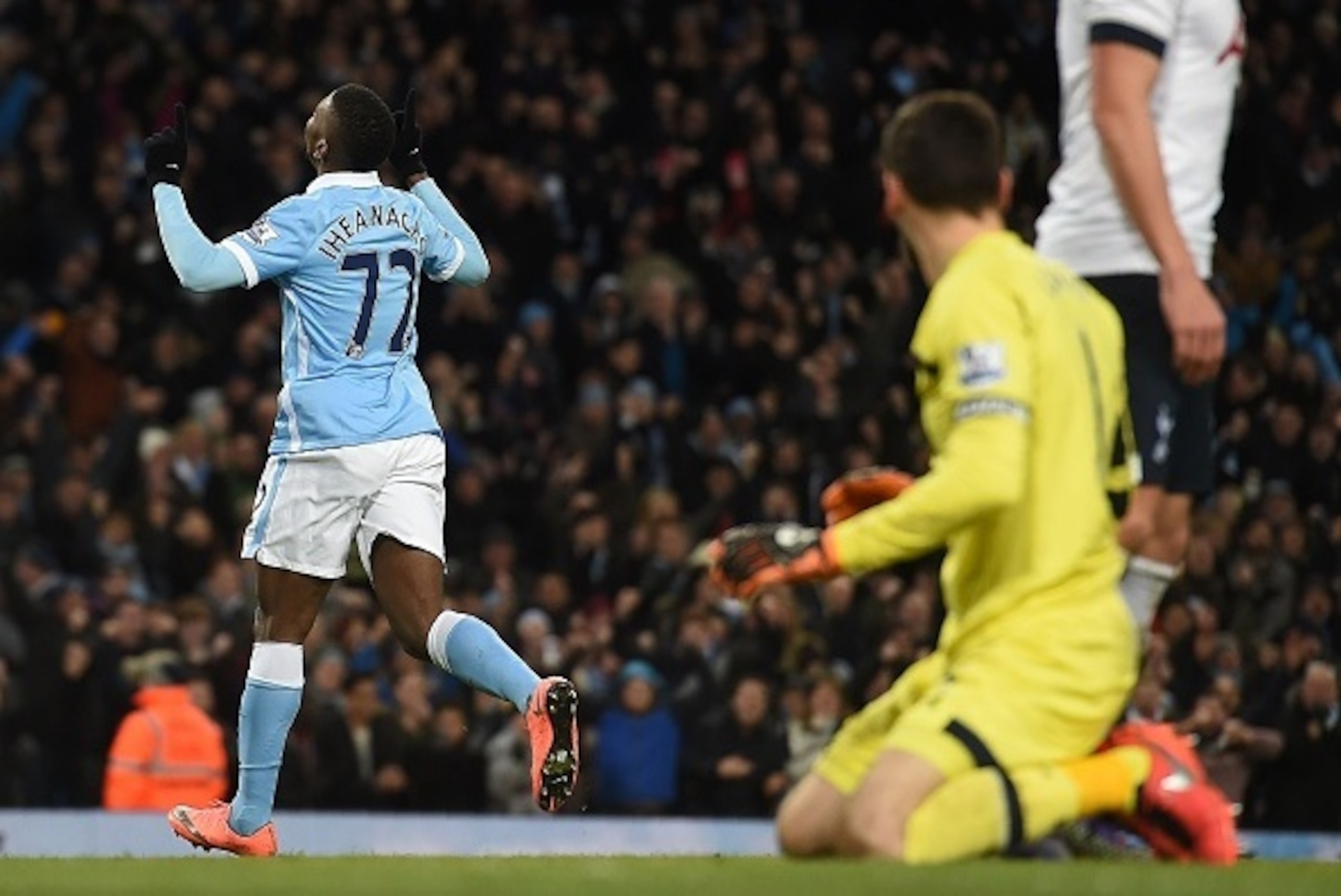 Manchester City's Nigerian striker Kelechi Iheanacho (L) runs past Tottenham Hotspur's French goalkeeper Hugo Lloris as he celebrates scoring his team's first goal during the English Premier League football match between Manchester City and Tottenham Hots