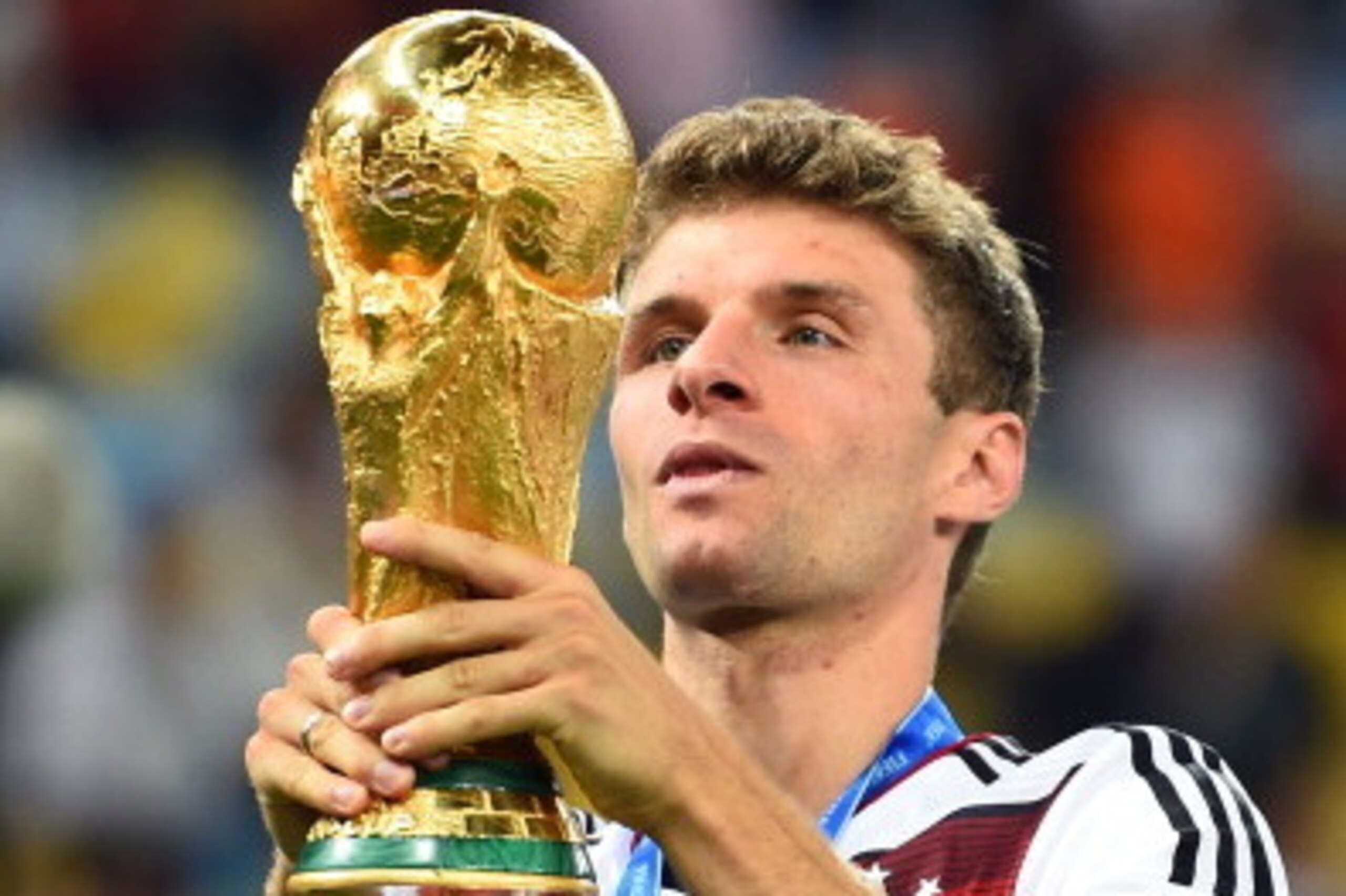 RIO DE JANEIRO, BRAZIL - JULY 13:  Thomas Mueller of Germany celebrates with the World Cup trophy  after defeating Argentina 1-0 in extra time during the 2014 FIFA World Cup Brazil Final match between Germany and Argentina at Maracana on July 13, 2014 in 