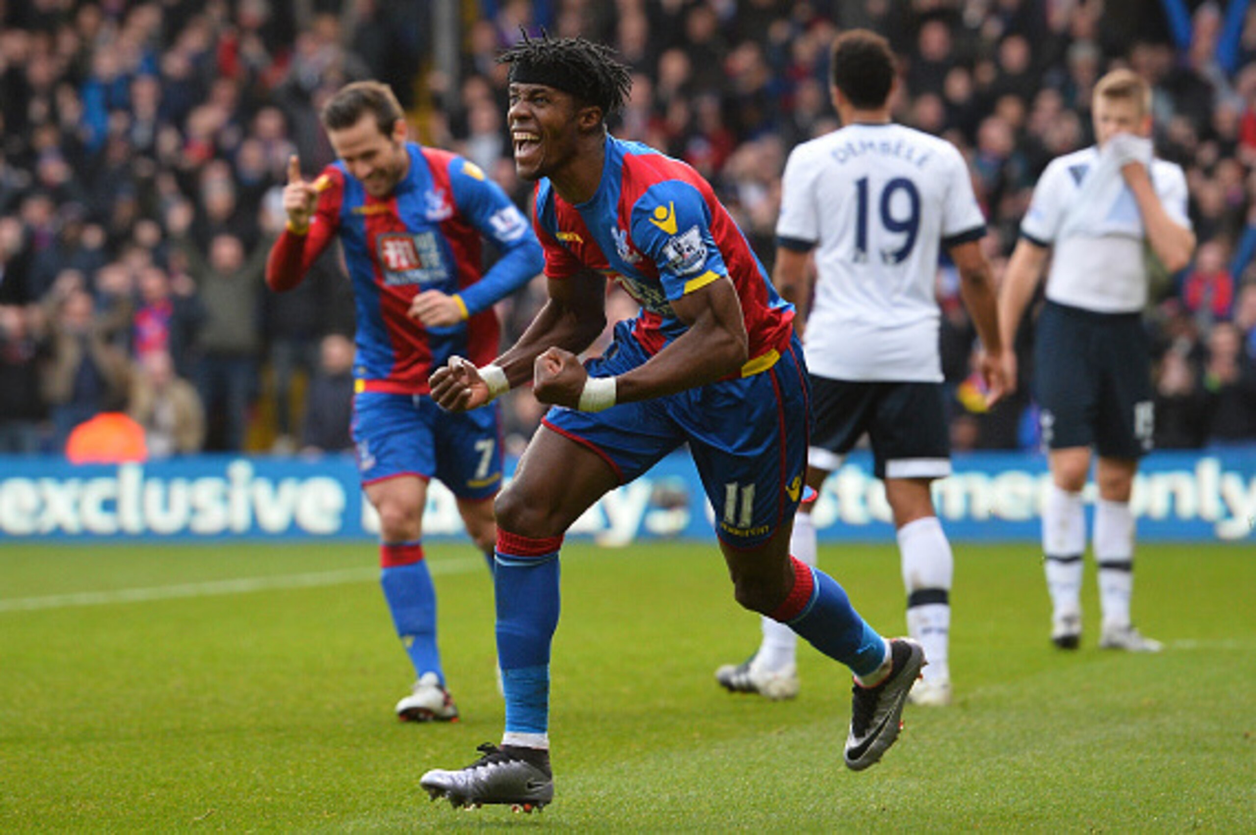 Crystal Palace's Ivorian-born English striker Wilfried Zaha (C) celebrates after his cross was turned into the Tottenham net by Tottenham Hotspur's Belgian defender Jan Vertonghen for an own goal to open the scoring during the English Premier League footb