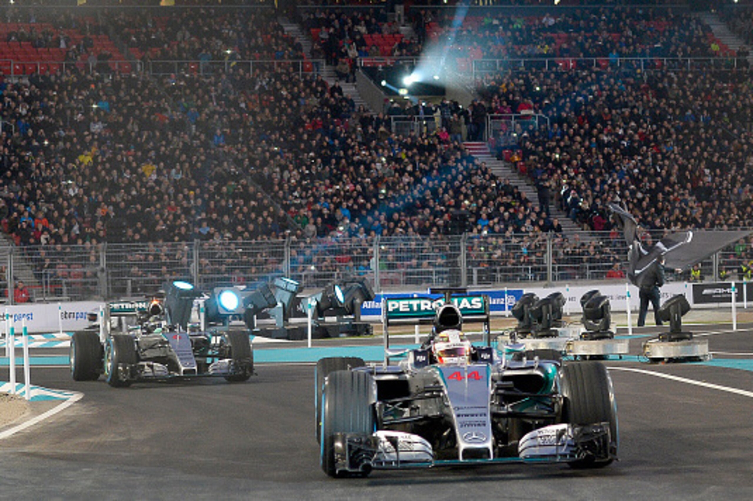 Mercedes-AMG's F1 British driver Lewis Hamilton steers his racer in front of his German teammate Nico Rosberg during the Mercedes-Benz 'Stars & Cars 2015' event at the Mercedes-Benz Arena in Stuttgart, southwestern Germany, on December 12, 2015.   / AFP /