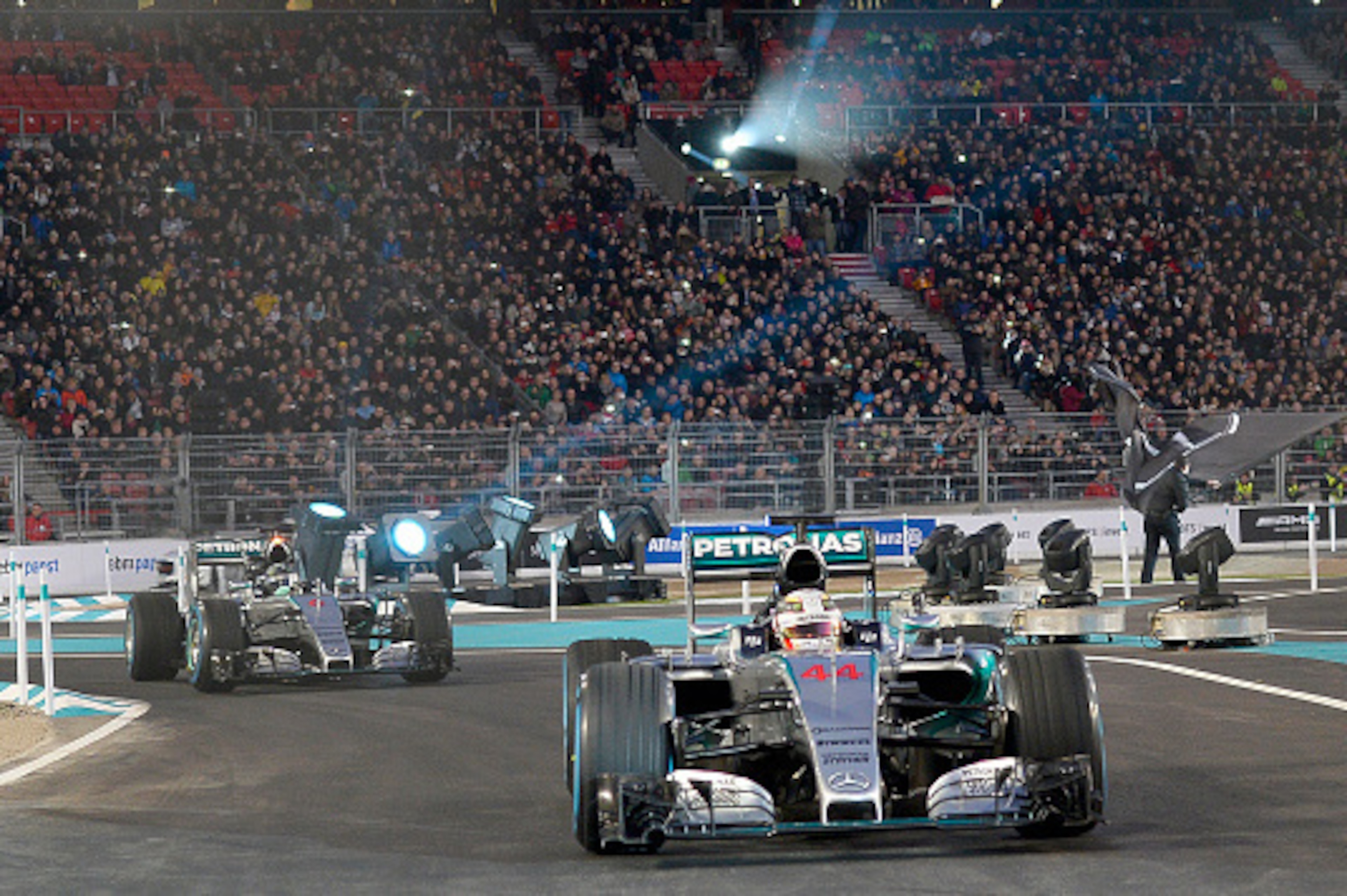 Mercedes-AMG's F1 British driver Lewis Hamilton steers his racer in front of his German teammate Nico Rosberg during the Mercedes-Benz 'Stars & Cars 2015' event at the Mercedes-Benz Arena in Stuttgart, southwestern Germany, on December 12, 2015.   / AFP /