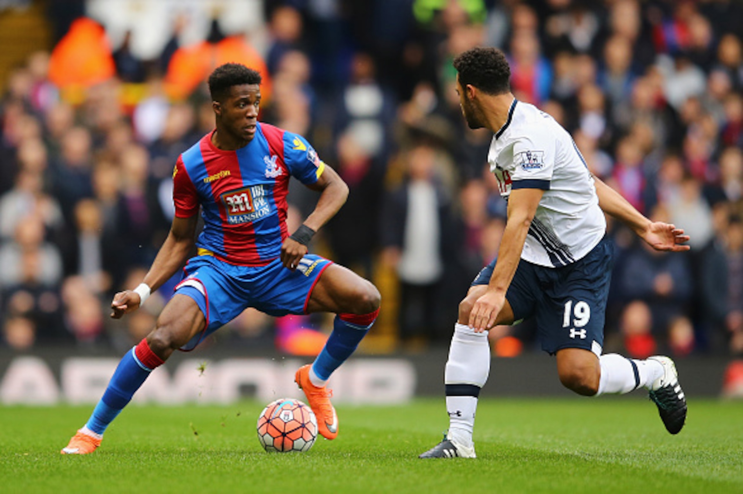 LONDON, ENGLAND - FEBRUARY 21: Wilfried Zaha of Crystal Palace takes on Mousa Dembele of Tottenham Hotspur during the Emirates FA Cup Fifth Round match between Tottenham Hotspur and Crystal Palace at White Hart Lane on February 21, 2016 in London, England