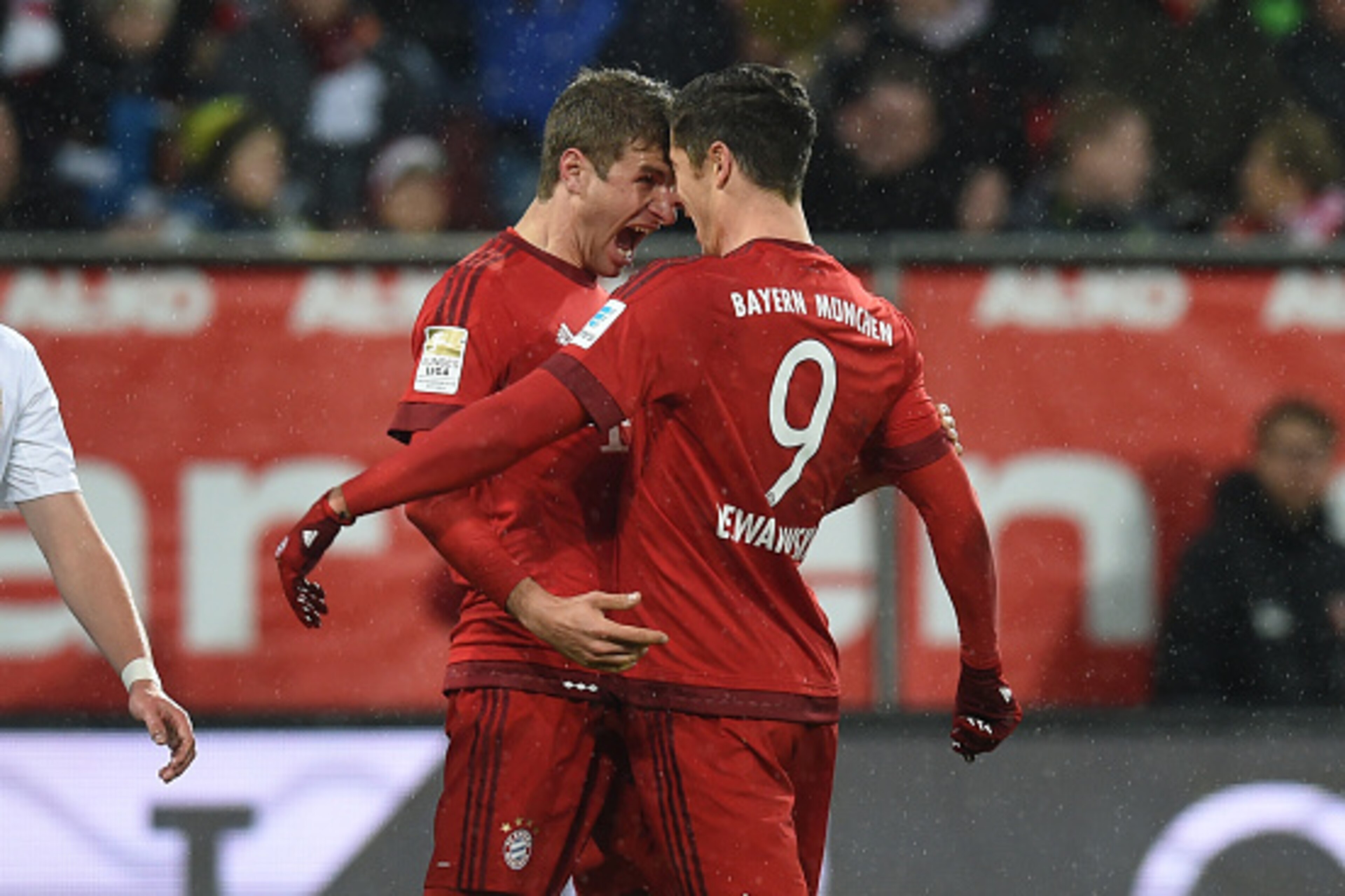 Bayern Munich's Polish striker Robert Lewandowski (R) and Bayern Munich's striker Thomas Mueller celebrate after Lewandowski scored the 0-1 goal during the German first division Bundesliga football match of FC Augsburg vs FC Bayern Munich in Augsburg, sou
