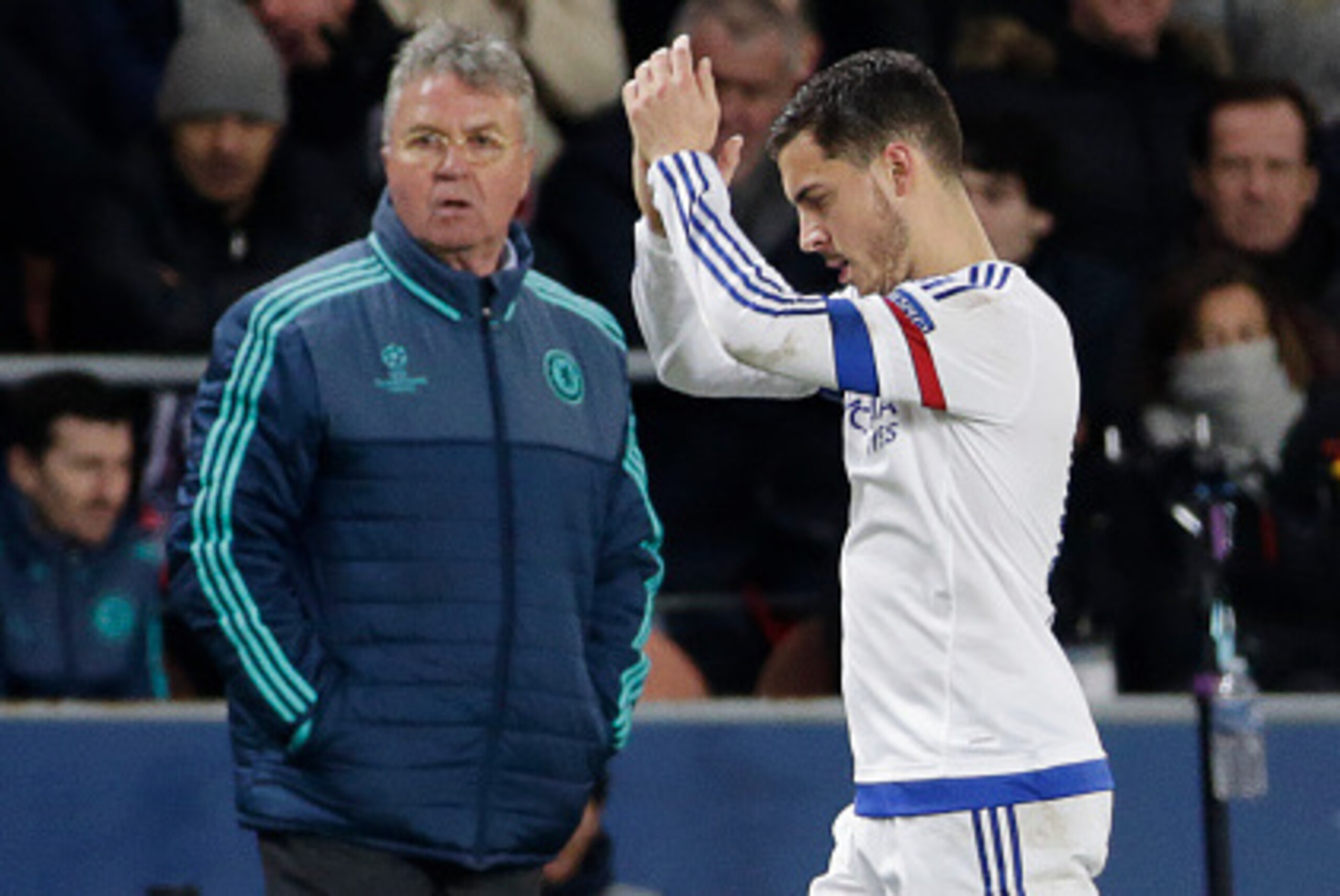 Chelsea's Belgian midfielder Eden Hazard (R) applauds as he passes Chelsea's Dutch coach Guus Hiddink  during the Champions League round of 16 first leg football match between Paris Saint-Germain (PSG) and Chelsea FC on February 16, 2016, at the Parc des 