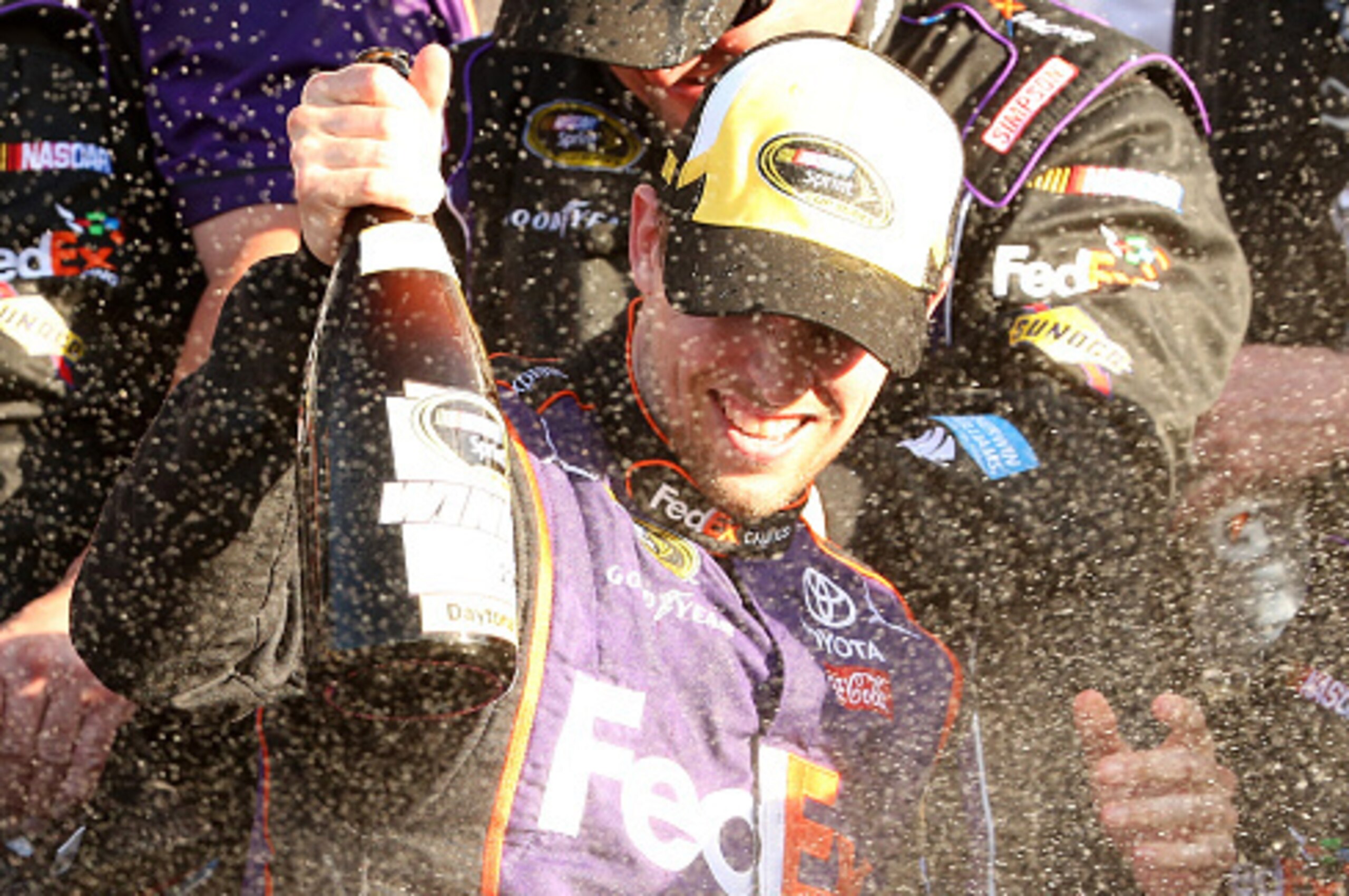 DAYTONA BEACH, FL - FEBRUARY 21: Denny Hamlin, driver of the #11 FedEx Express Toyota, celebrates with champagne in Victory Lane after winning the NASCAR Sprint Cup Series DAYTONA 500 at Daytona International Speedway on February 21, 2016 in Daytona Beac DAYTONA BEACH, FL - FEBRUARY 21: Denny Hamlin, driver of the #11 FedEx Express Toyota, celebrates with champagne in Victory Lane after winning the NASCAR Sprint Cup Series DAYTONA 500 at Daytona International Speedway on February 21, 2016 in Daytona Beac