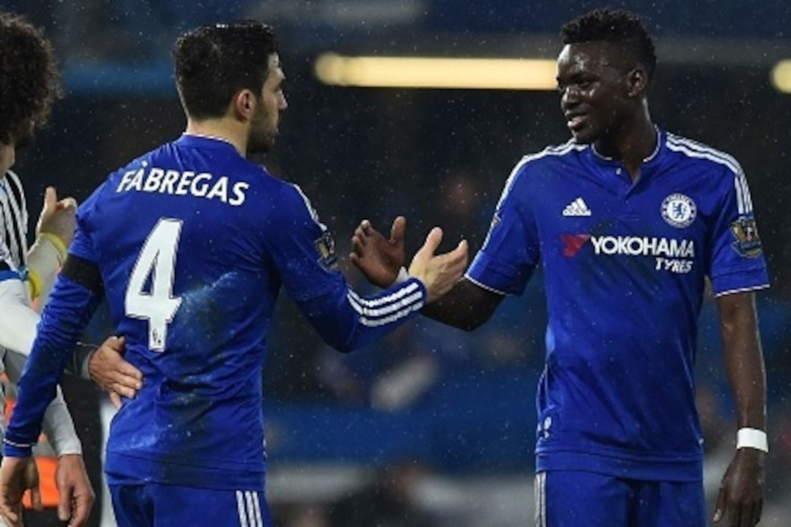 Chelsea's Burkina Faso midfielder Bertrand Traore (R) shakes hands with Chelsea's Spanish midfielder Cesc Fabregas (2R) at the end of the English Premier League football match between Chelsea and Newcastle United at Stamford Bridge in London on February 1