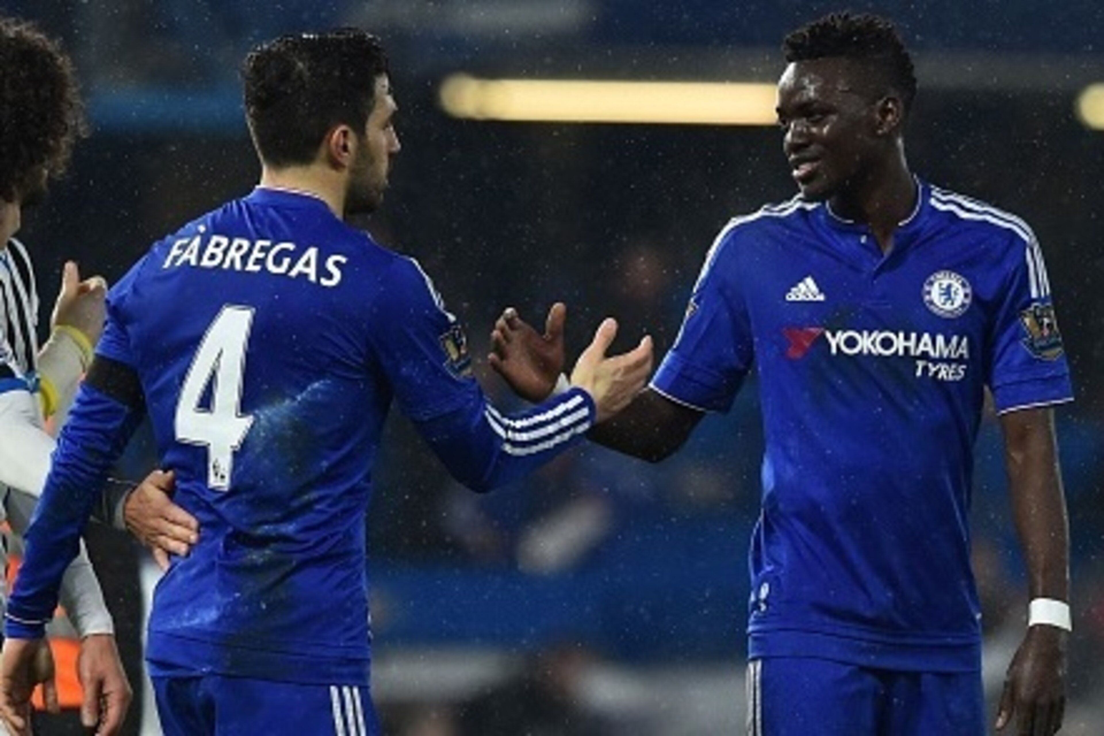 Chelsea's Burkina Faso midfielder Bertrand Traore (R) shakes hands with Chelsea's Spanish midfielder Cesc Fabregas (2R) at the end of the English Premier League football match between Chelsea and Newcastle United at Stamford Bridge in London on February 1