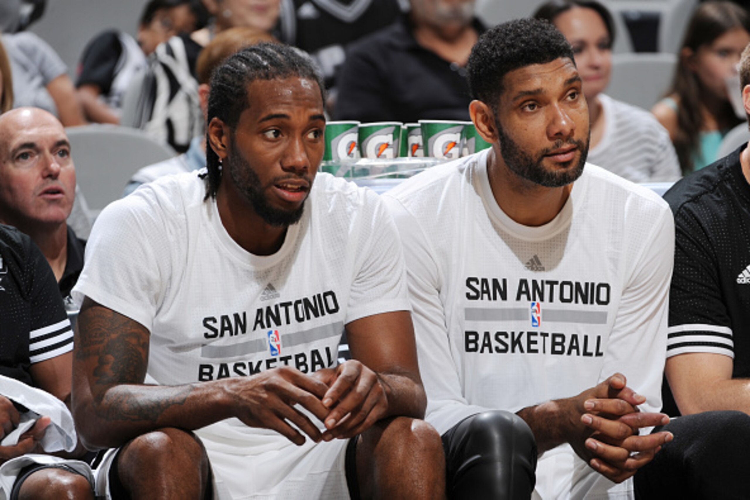 SAN ANTONIO, TX - OCTOBER 18:  Kawhi Leonard #2 of the San Antonio Spurs and Tim Duncan #21 of the San Antonio Spurs sit on the bench against the Detroit Pistons during a preseason game on October 18, 2015 at the AT&T Center in San Antonio, Texas. NOTE TO