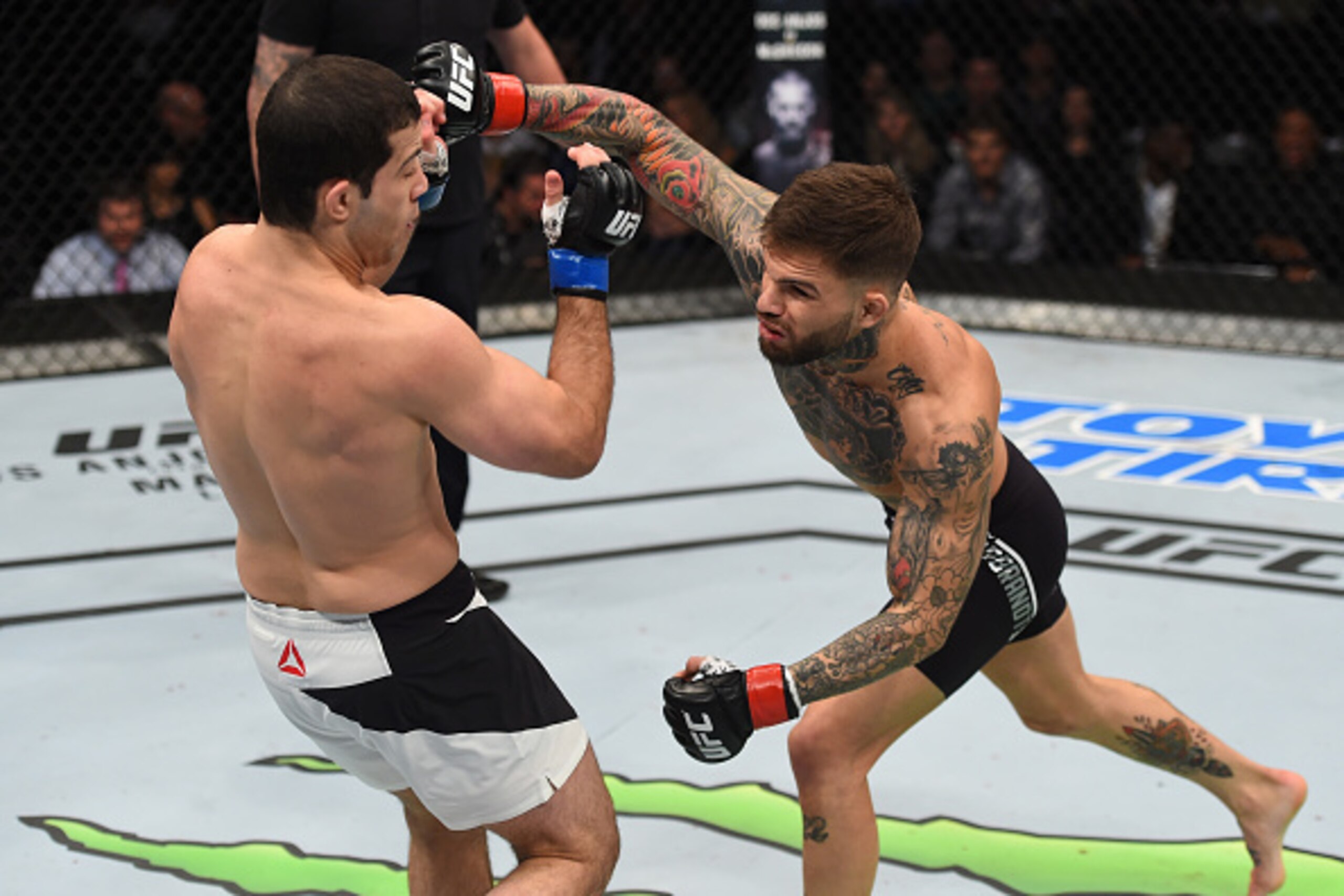 PITTSBURGH, PA - FEBRUARY 21:  (R-L) Cody Garbrandt punches Augusto Mendes in their bantamweight bout during the UFC Fight Night event at Consol Energy Center on February 21, 2016 in Pittsburgh, Pennsylvania. (Photo by Jeff Bottari/Zuffa LLC/Zuffa LLC via