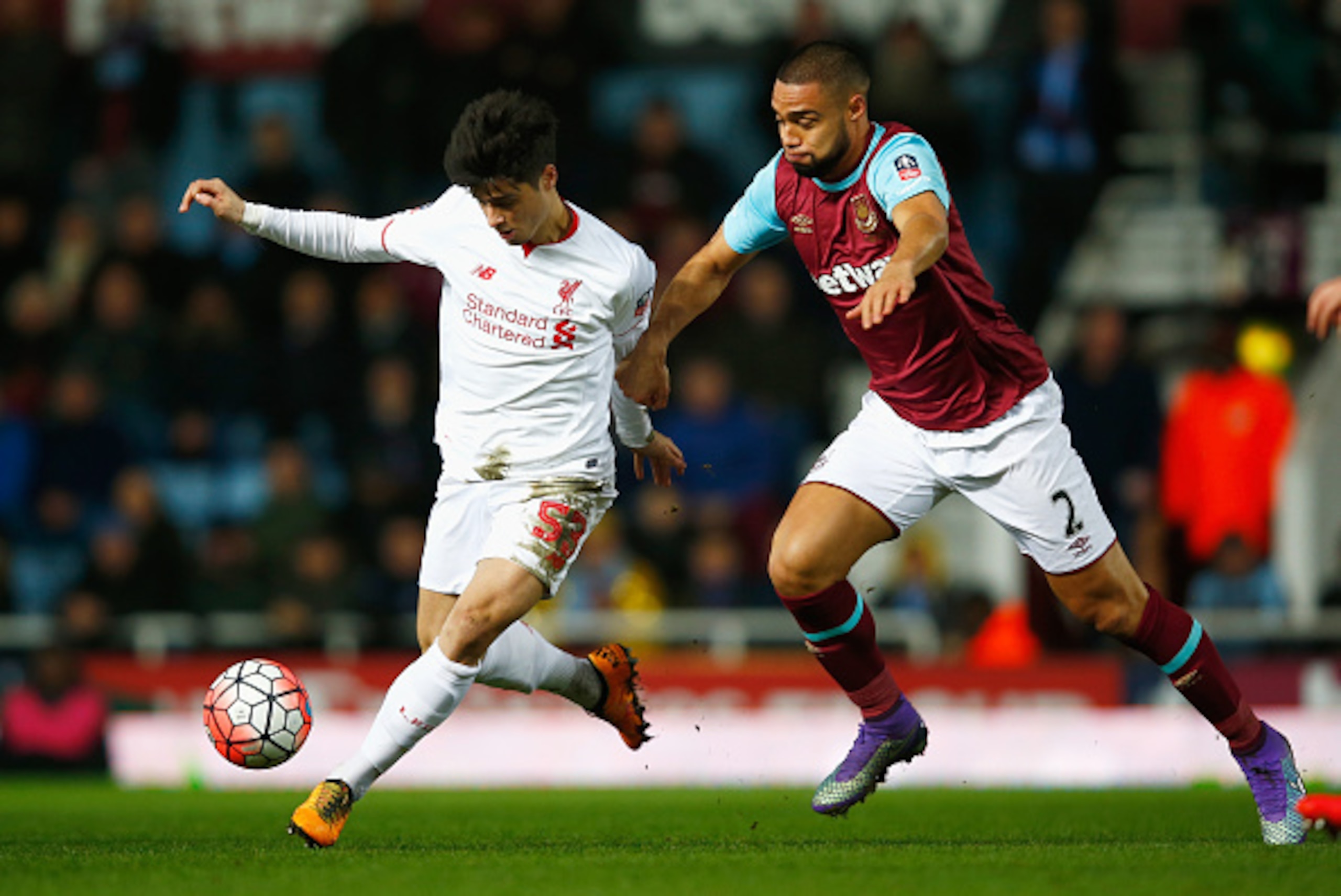 LONDON, ENGLAND - FEBRUARY 09:  Joao Carlos Teixeira of Liverpool evades Winston Reid of West Ham United during the Emirates FA Cup Fourth Round Replay match between West Ham United and Liverpool at Boleyn Ground on February 9, 2016 in London, England.  (