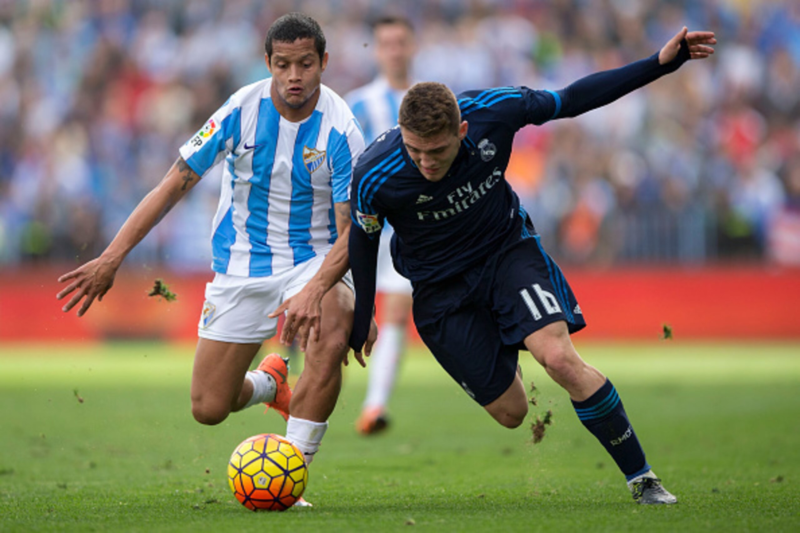 MALAGA, SPAIN - FEBRUARY 21: Mateo Kovacic (R) of Real Madrid CF competes for the ball with Roberto Rosales (L) of Malaga CF during the La Liga match between Malaga CF and Real Madrid CF at La Rosaleda Stadium on February 21, 2016 in Malaga, Spain.  (Phot