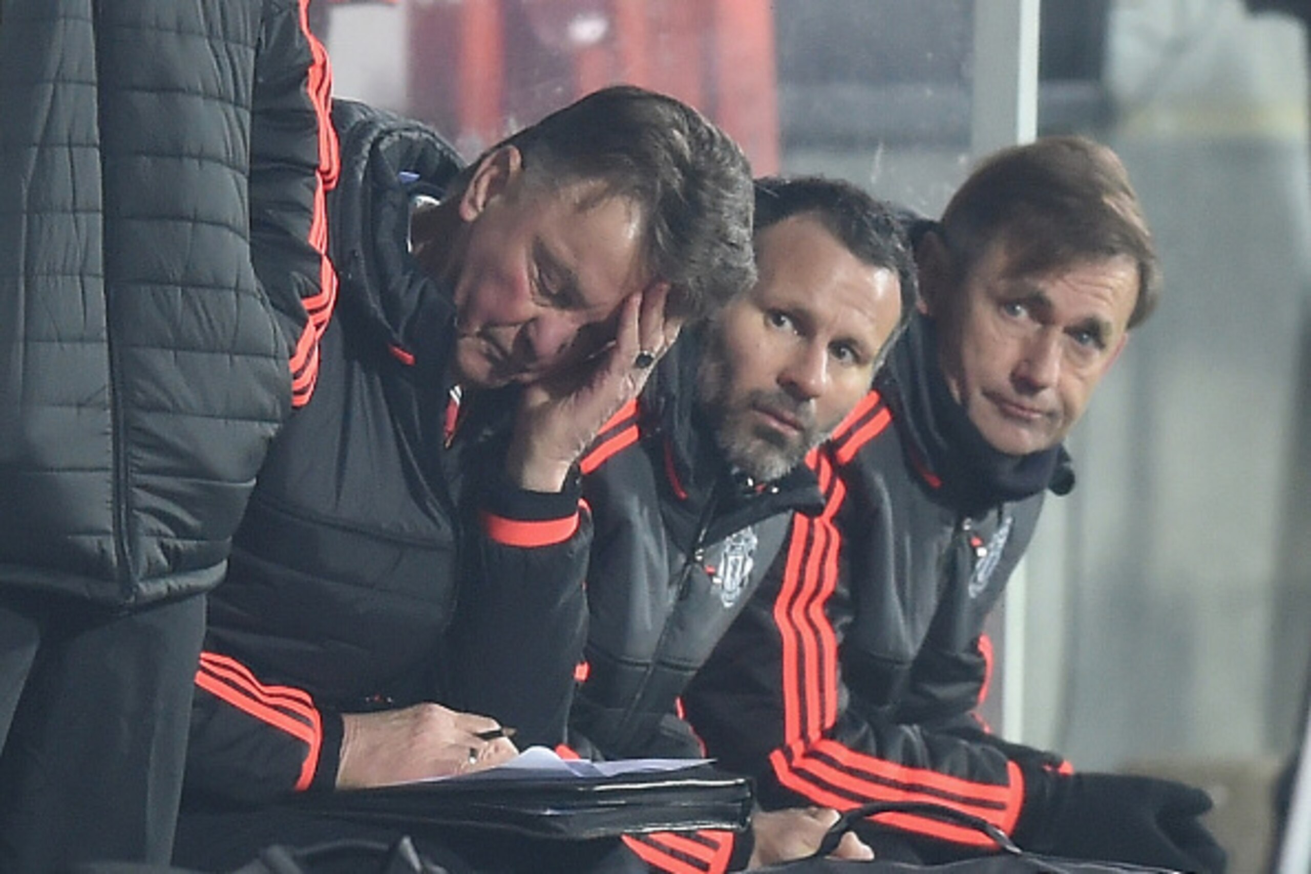 HERNING, DENMARK - FEBRUARY 18:  Louis van Gaal (L) Manager of Manchester United scratches his head while Ryan Giggs (C) assistant manager looks on during the UEFA Europa League round of 32 first leg match between FC Midtjylland and Manchester United at H