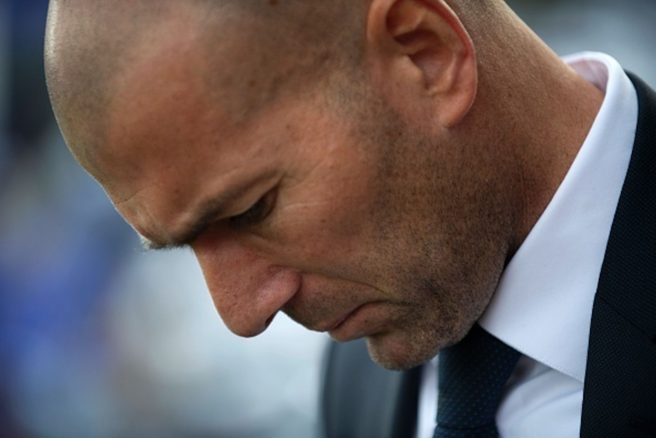 Real Madrid's French head coach Zinedine Zidane looks downwards before the Spanish league football match Malaga CF vs Real Madrid CF at La Rosaleda stadium in Malaga on February 21, 2016. / AFP / JORGE GUERRERO        (Photo credit should read JORGE GUERR
