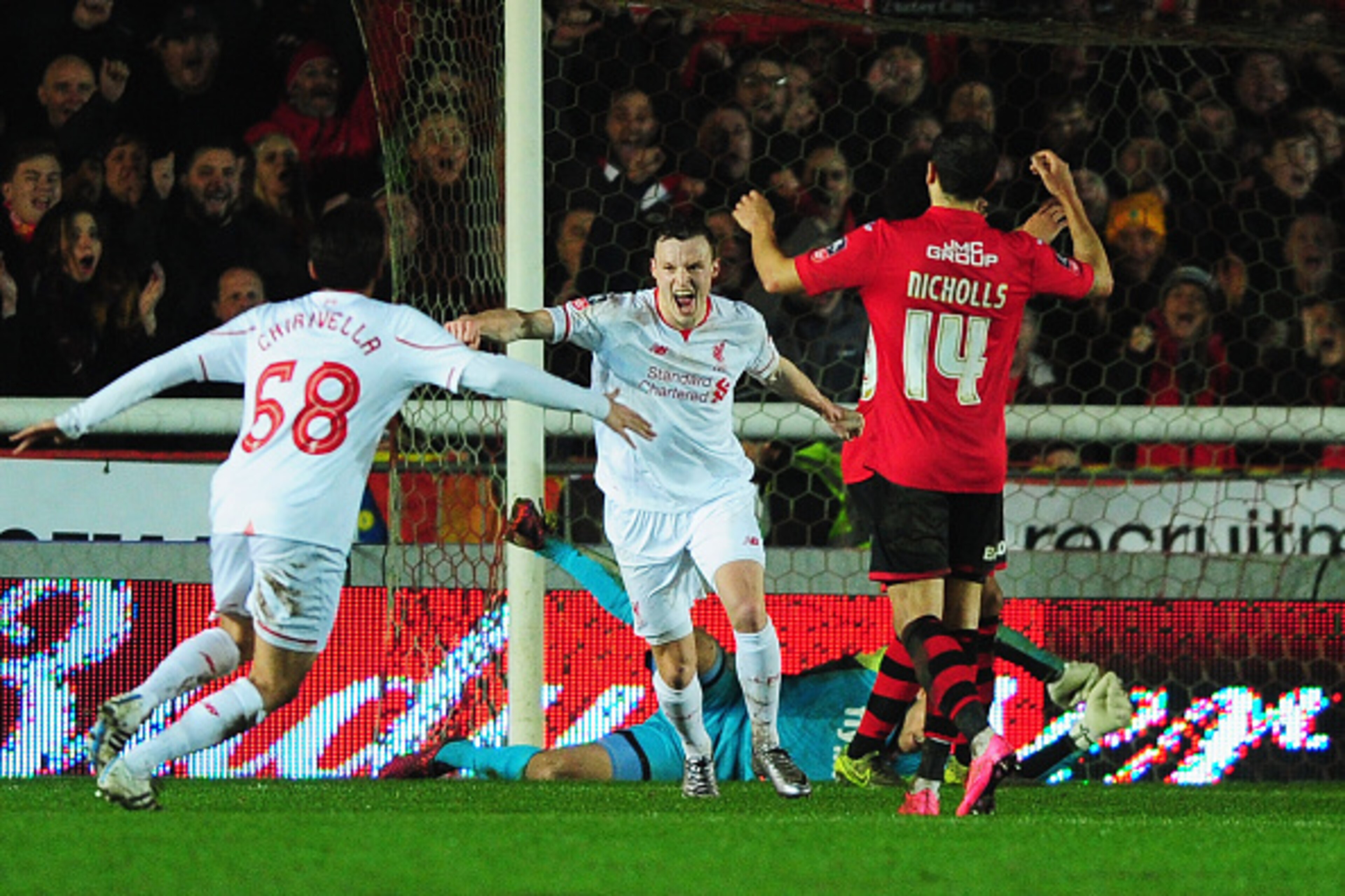 EXETER, ENGLAND - JANUARY 08:  Alex Nicholls of Exeter City (14) reacts as Brad Smith of Liverpool (C) celebrates scoring their second goal with Pedro Chirivella (68) during the Emirates FA Cup third round match between Exeter City and Liverpool at St Jam