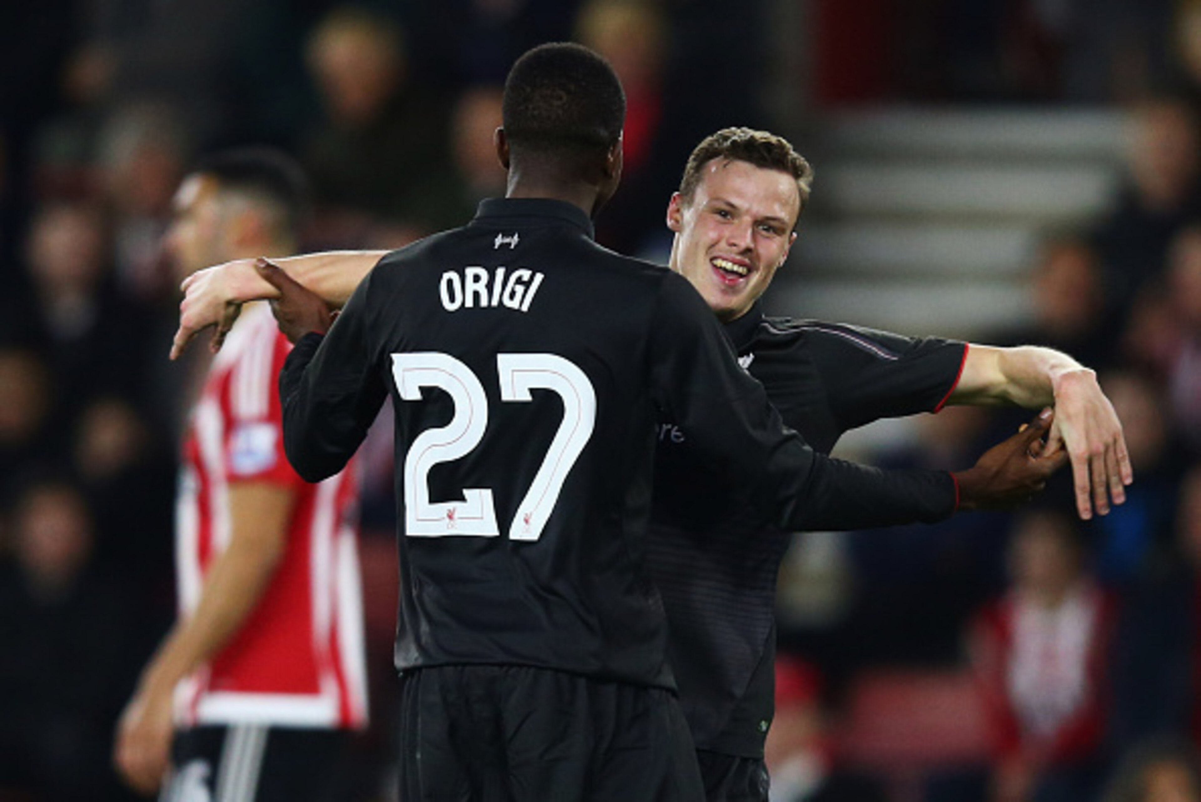 SOUTHAMPTON, ENGLAND - DECEMBER 02:  Divock Origi of Liverpool (27) celebrates with Brad Smith as he scores their sixth goal and completes his hat trick during the Capital One Cup quarter final match between Southampton and Liverpool at St Mary's Stadium 