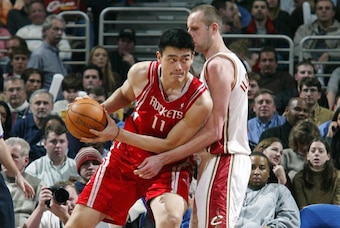 CLEVELAND - DECEMBER 17:  Yao Ming #11 of the Houston Rockets pushes to the basket against Zydrunas Ilgauskas of the  Cleveland Cavaliers at Gund Arena December 17, 2003 in Cleveland, Ohio.  NOTE TO USER: User expressly acknowledges and agrees that, by do