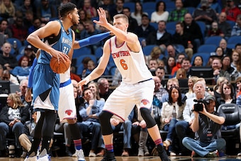 MINNEAPOLIS, MN -  FEBRUARY 20: Karl-Anthony Towns #32 of the Minnesota Timberwolves handles the ball during the game against Kristaps Porzingis #6 of the New York Knicks on February 20, 2016 at Target Center in Minneapolis, Minnesota. NOTE TO USER: User 