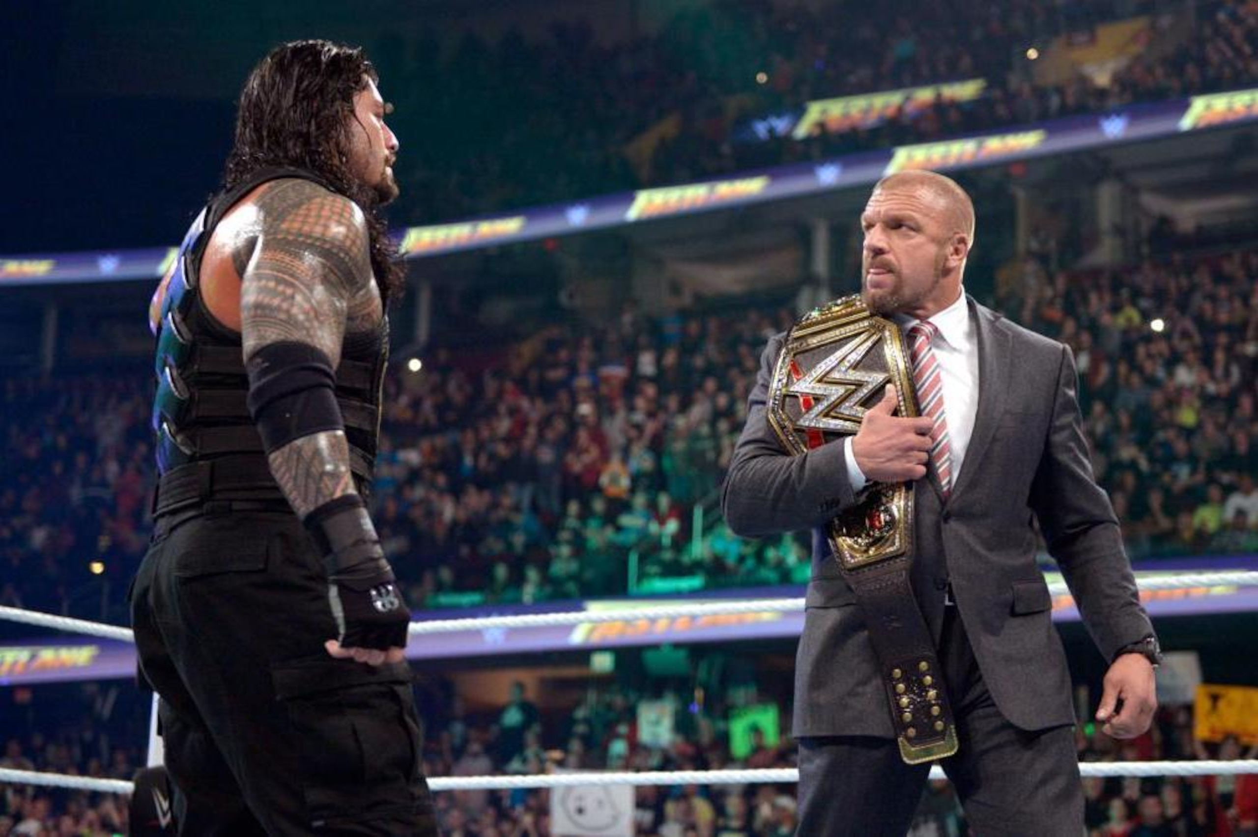 Roman Reigns and Triple H stare each other down after The Big Dog's win at Fastlane.