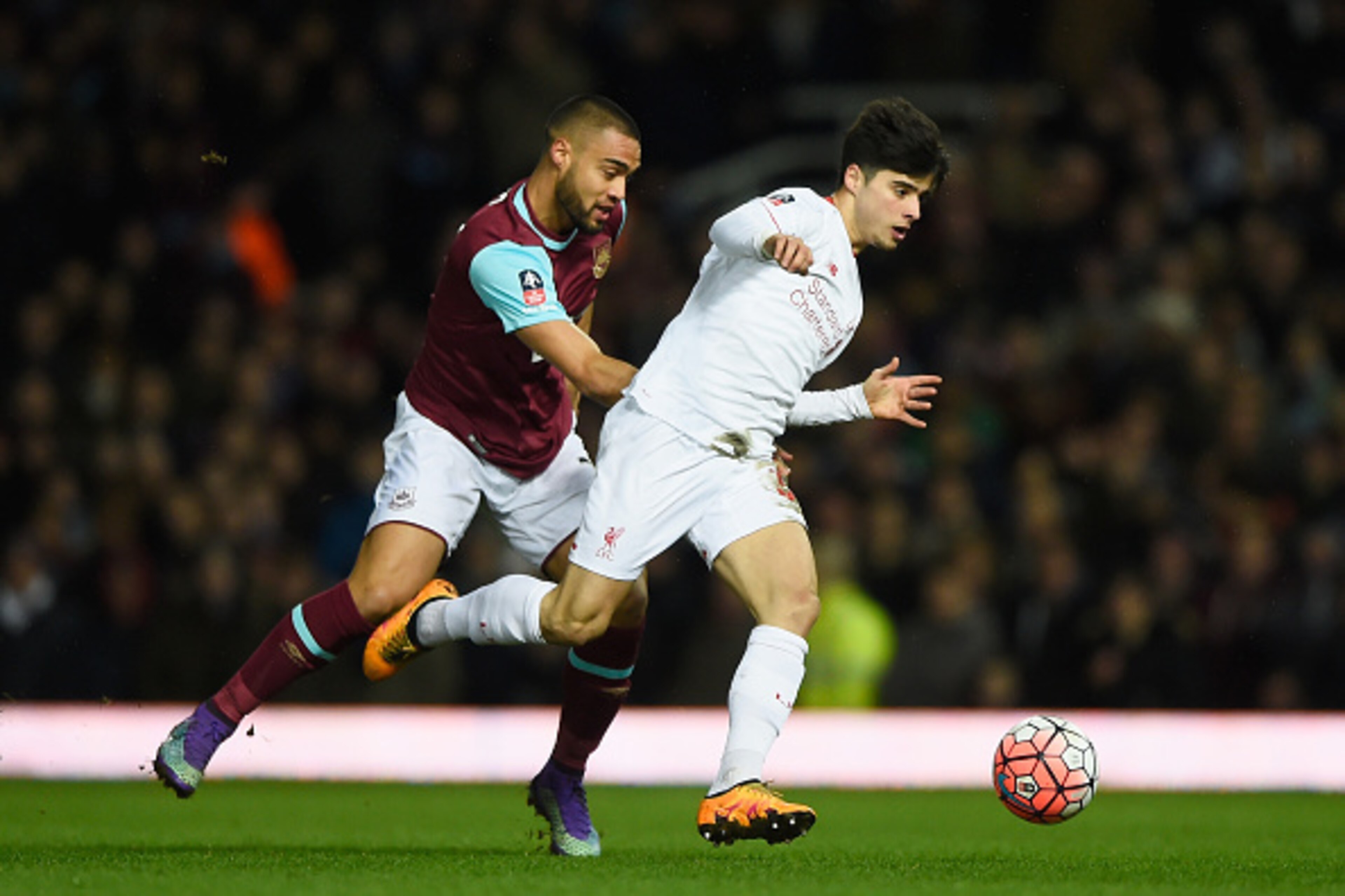 LONDON, ENGLAND - FEBRUARY 09:  Joao Carlos Teixeira of Liverpool evades Winston Reid of West Ham United during the Emirates FA Cup Fourth Round Replay match between West Ham United and Liverpool at Boleyn Ground on February 9, 2016 in London, England.  (