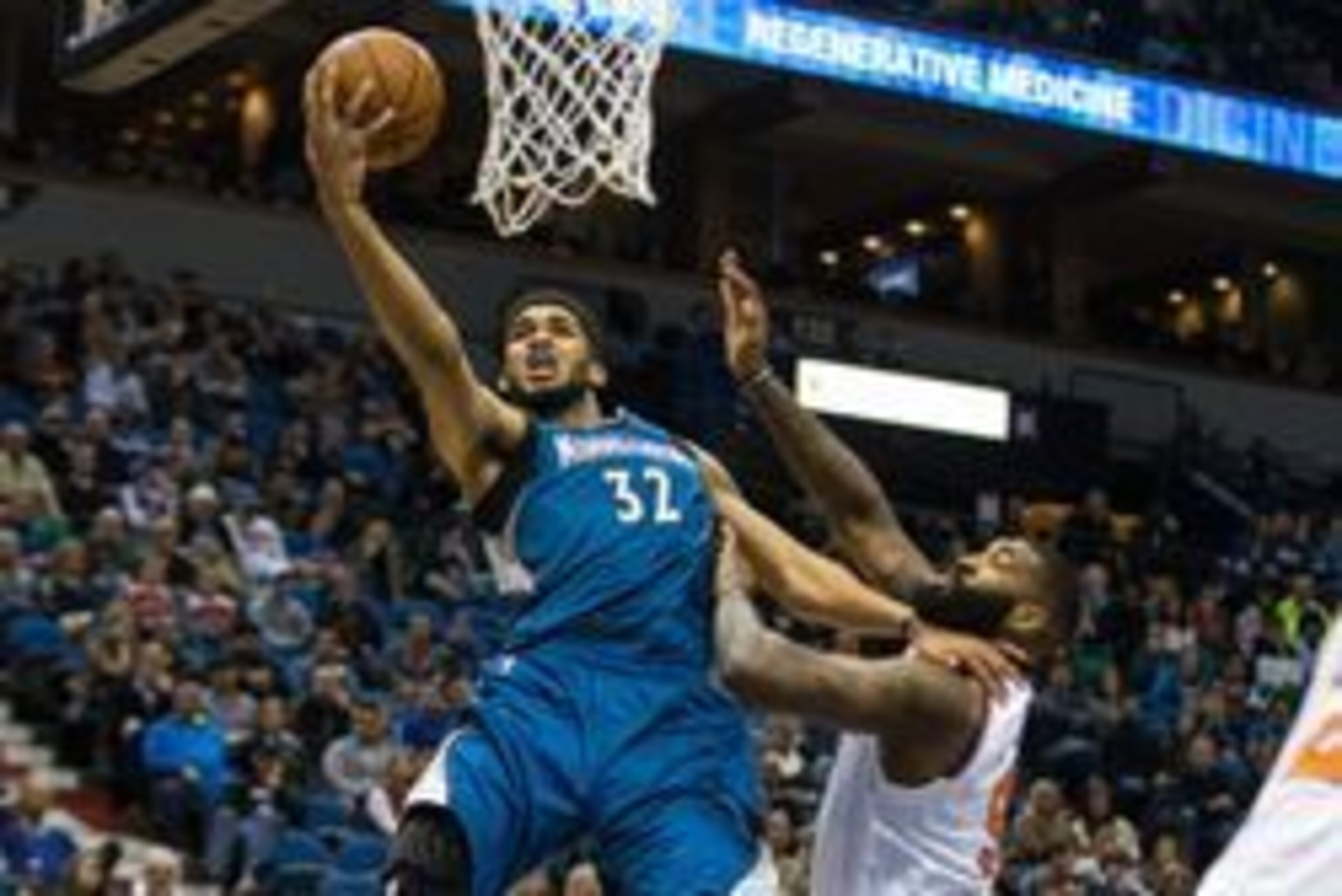 Feb 20, 2016; Minneapolis, MN, USA; Minnesota Timberwolves center Karl-Anthony Towns (32) shoots and is fouled by New York Knicks forward Kyle O'Quinn (9) during the fourth quarter at Target Center. Mandatory Credit: Brace Hemmelgarn-USA TODAY Sports