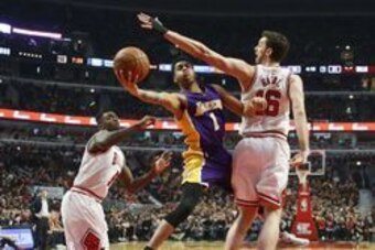 Feb 21, 2016; Chicago, IL, USA; Los Angeles Lakers guard D'Angelo Russell (1) goes to the basket between Chicago Bulls forward Bobby Portis (5) and center Pau Gasol (16) during the first half at United Center. Mandatory Credit: Kamil Krzaczynski-USA TODAY