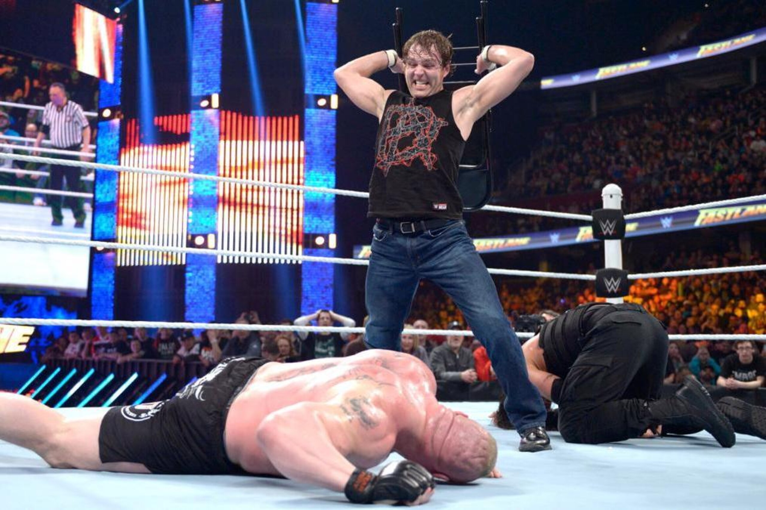 Dean Ambrose lays out Brock Lesnar with a chair.