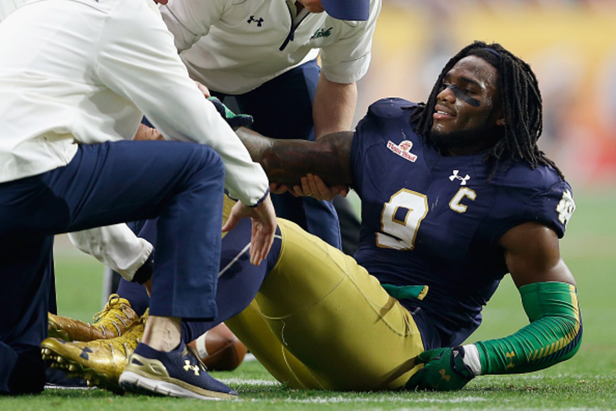 GLENDALE, AZ - JANUARY 01:  Linebacker Jaylon Smith #9 of the Notre Dame Fighting Irish lays on the field after an injury during the first quarter of the BattleFrog Fiesta Bowl against the Ohio State Buckeyes at University of Phoenix Stadium on January 1,
