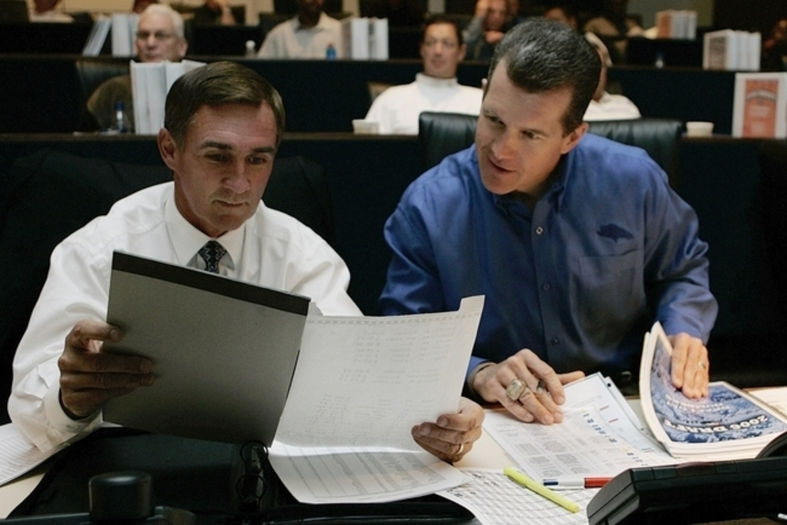 Ted Sundquist and Mike Shanahan poring over the numbers.
