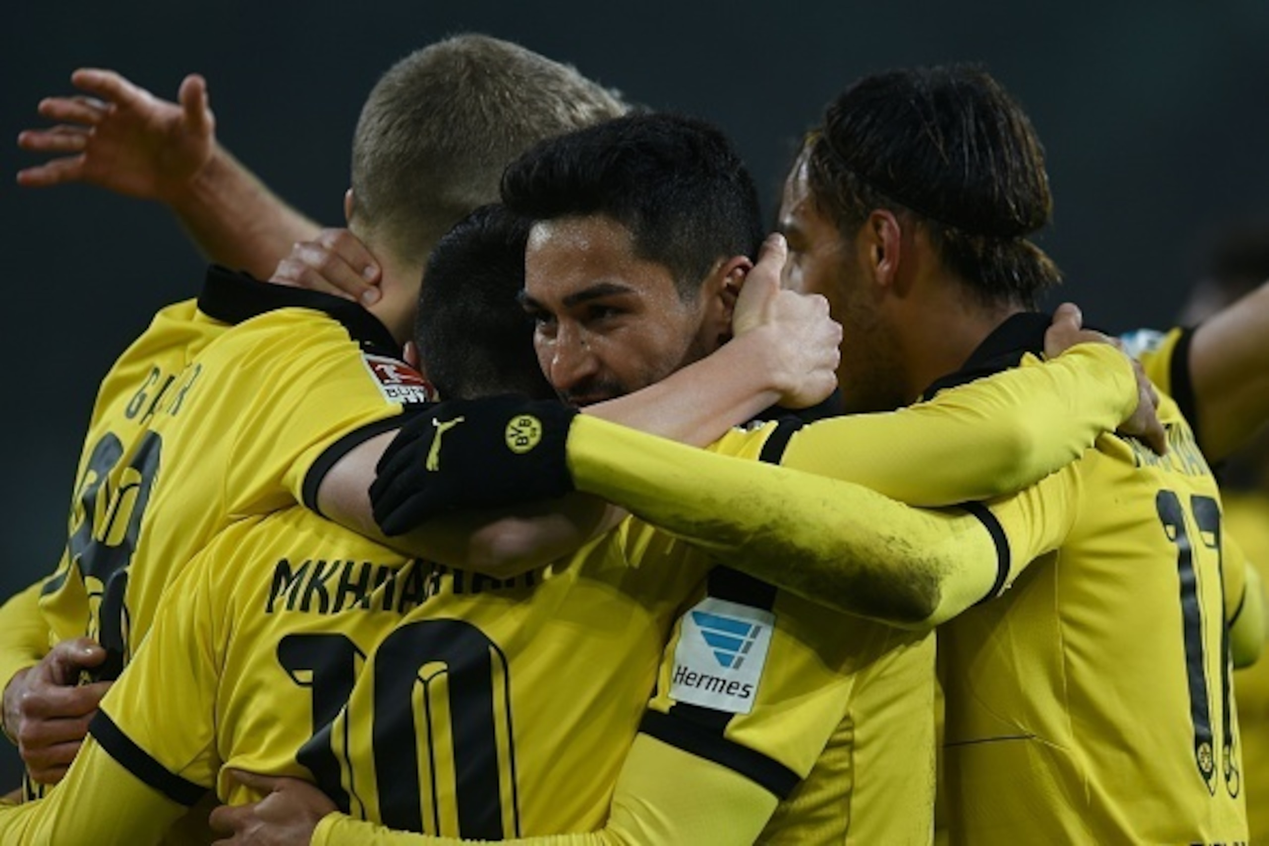 Dortmund's Armenian midfielder Henrikh Mkhitaryan (back) and Dortmund's midfielder Ilkay Guendogan celebrate the third goal during the German first division football Bundesliga match Borussia Moenchengladbach vs Borussia Dortmund in Moenchengladbach, west