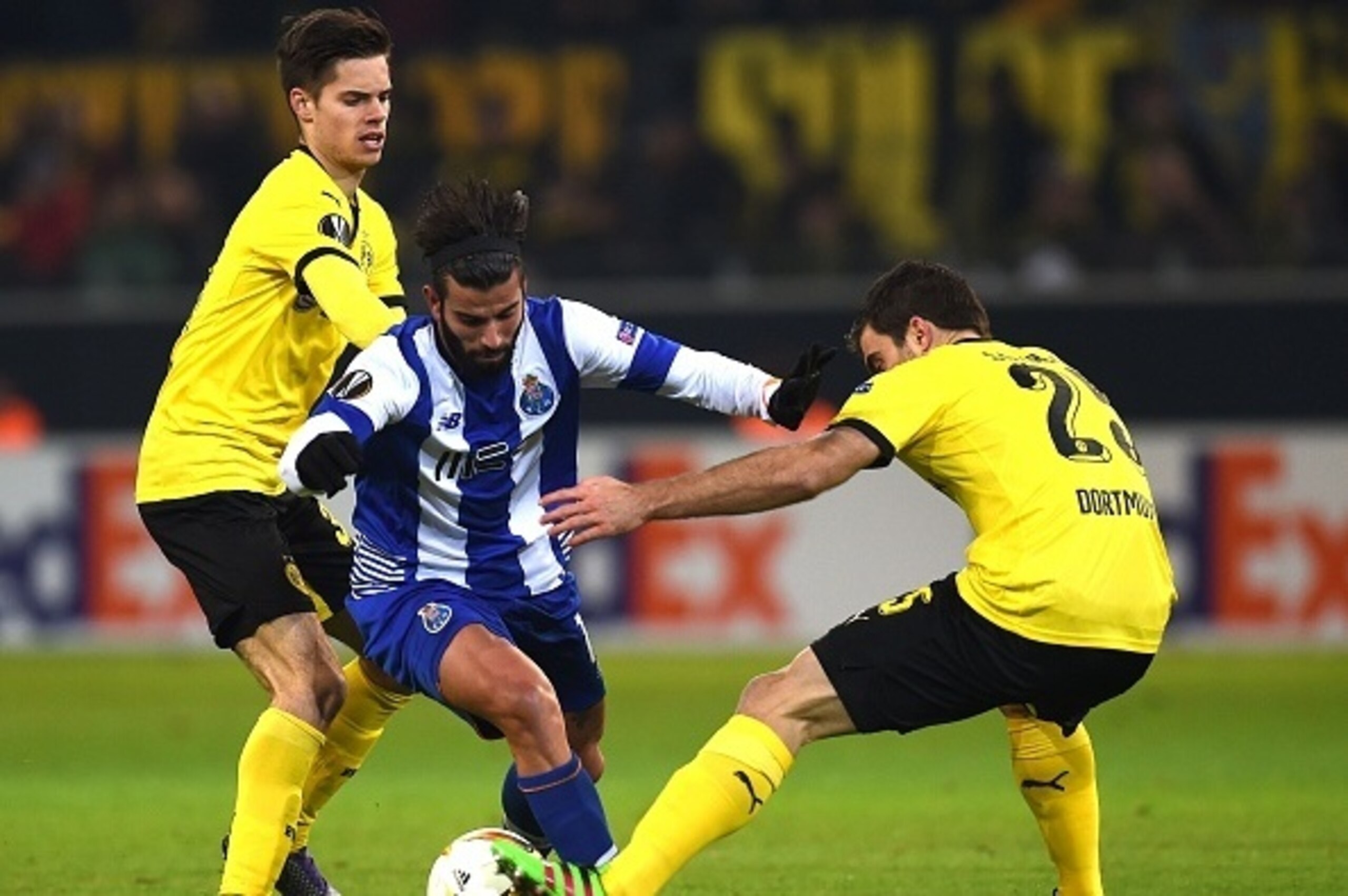 Dortmund's midfielder Julian Weigl (L) and Dortmund's Greek defender Sokratis vies with Porto´s Sergio Oliveira (C) during the UEFA Europa League Round of 32 football match between Borussia Dortmund and FC Porto in Dortmund, western Germany on February 18