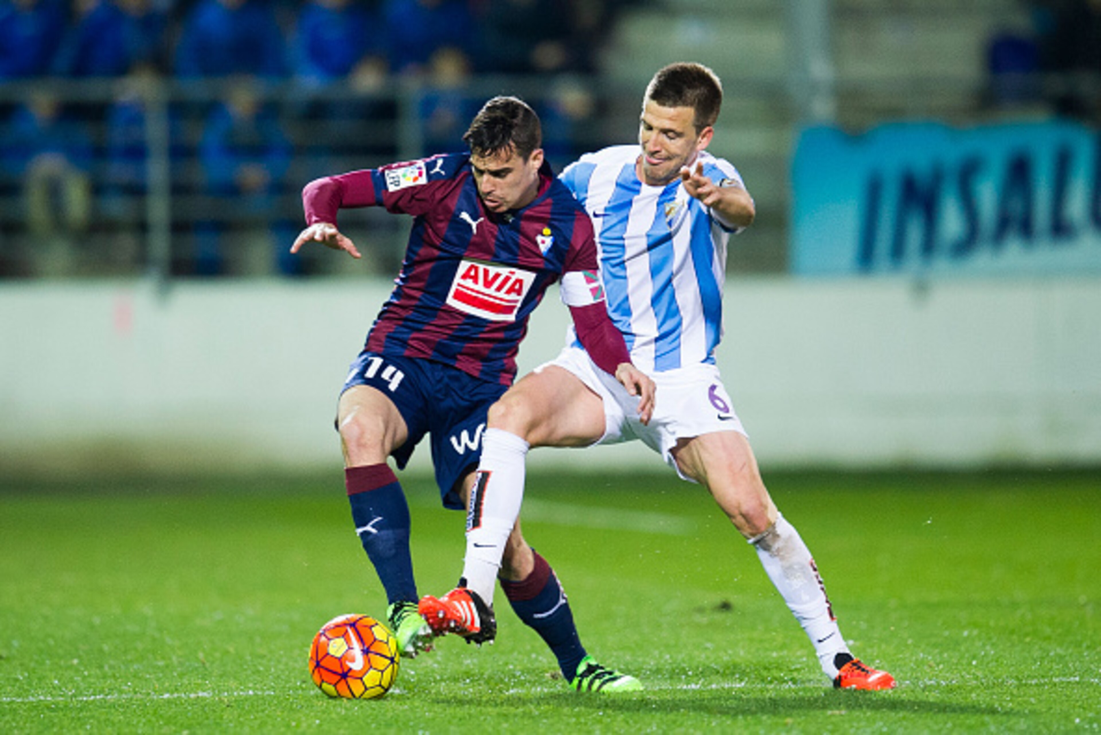EIBAR, SPAIN - JANUARY 30: Daniel Garcia of SD Eibar duels for the ball with Ignacio Camacho of Malaga CF during the La Liga match between SD Eibar and Malaga CF at Ipurua Municipal Stadium on January 30, 2016 in Eibar, Spain.  (Photo by Juan Manuel Serra