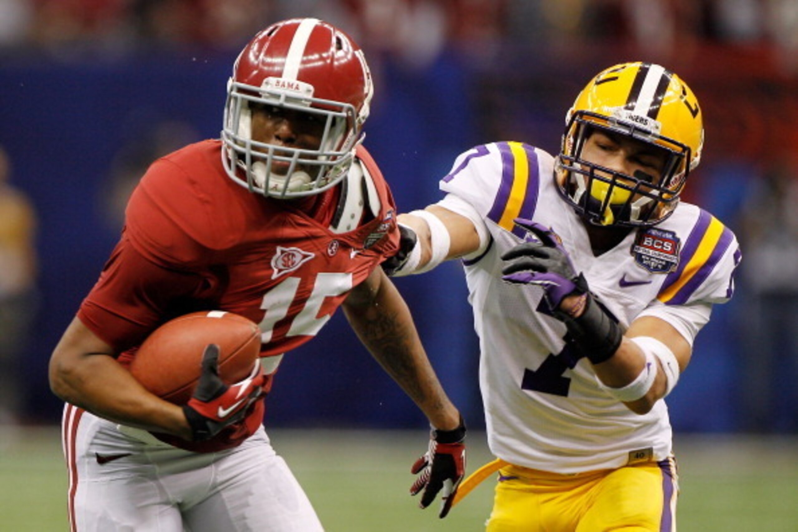 NEW ORLEANS, LA - JANUARY 09:  Darius Hanks #15 of the Alabama Crimson Tide runs as Tyrann Mathieu #7 of the Louisiana State University Tigers pulls his jersey from behind during the 2012 Allstate BCS National Championship Game at Mercedes-Benz Superdome 