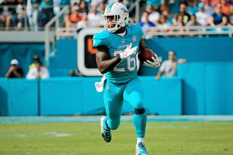 MIAMI GARDENS, FL - JANUARY 03:  Lamar Miller #26 of the Miami Dolphins in action during the first half of the game against the New England Patriots at Sun Life Stadium on January 3, 2016 in Miami Gardens, Florida.  (Photo by Mike Ehrmann/Getty Images)