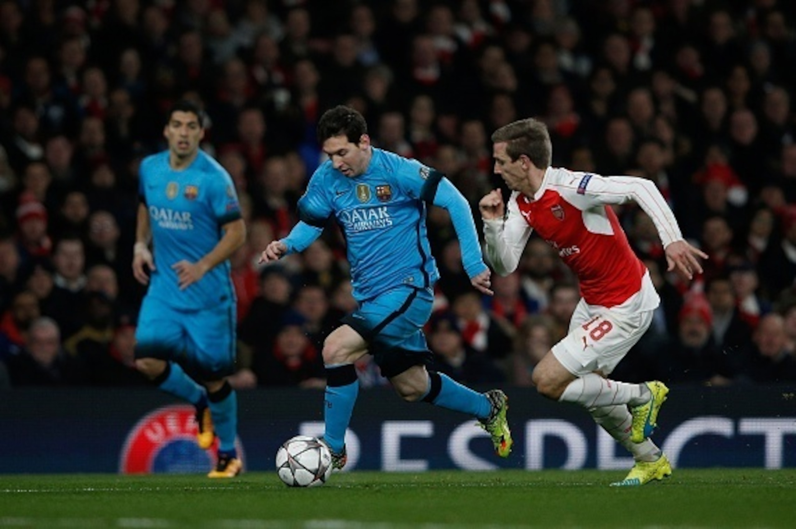 Arsenal's Spanish defender Nacho Monreal (R) vies with Barcelona's Argentinian forward Lionel Messi during the UEFA Champions League round of 16 1st leg football match between Arsenal and Barcelona at the Emirates Stadium in London on February 23, 2016. 
