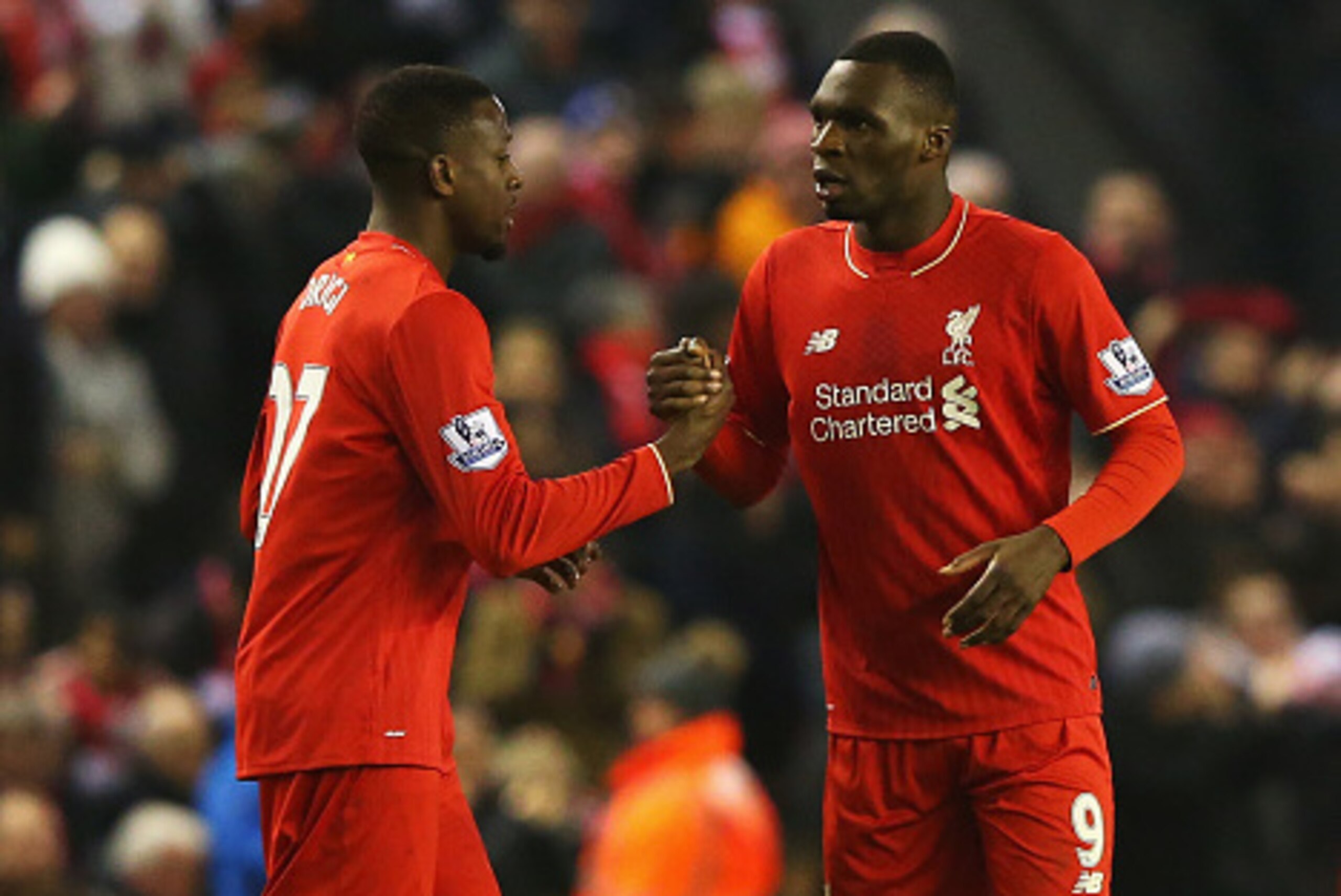 LIVERPOOL, ENGLAND - DECEMBER 13:  Divock Origi of Liverpool (L) celebrates with Christian Benteke as he scores their second goal during the Barclays Premier League match between Liverpool and West Bromwich Albion at Anfield on December 13, 2015 in Liverp