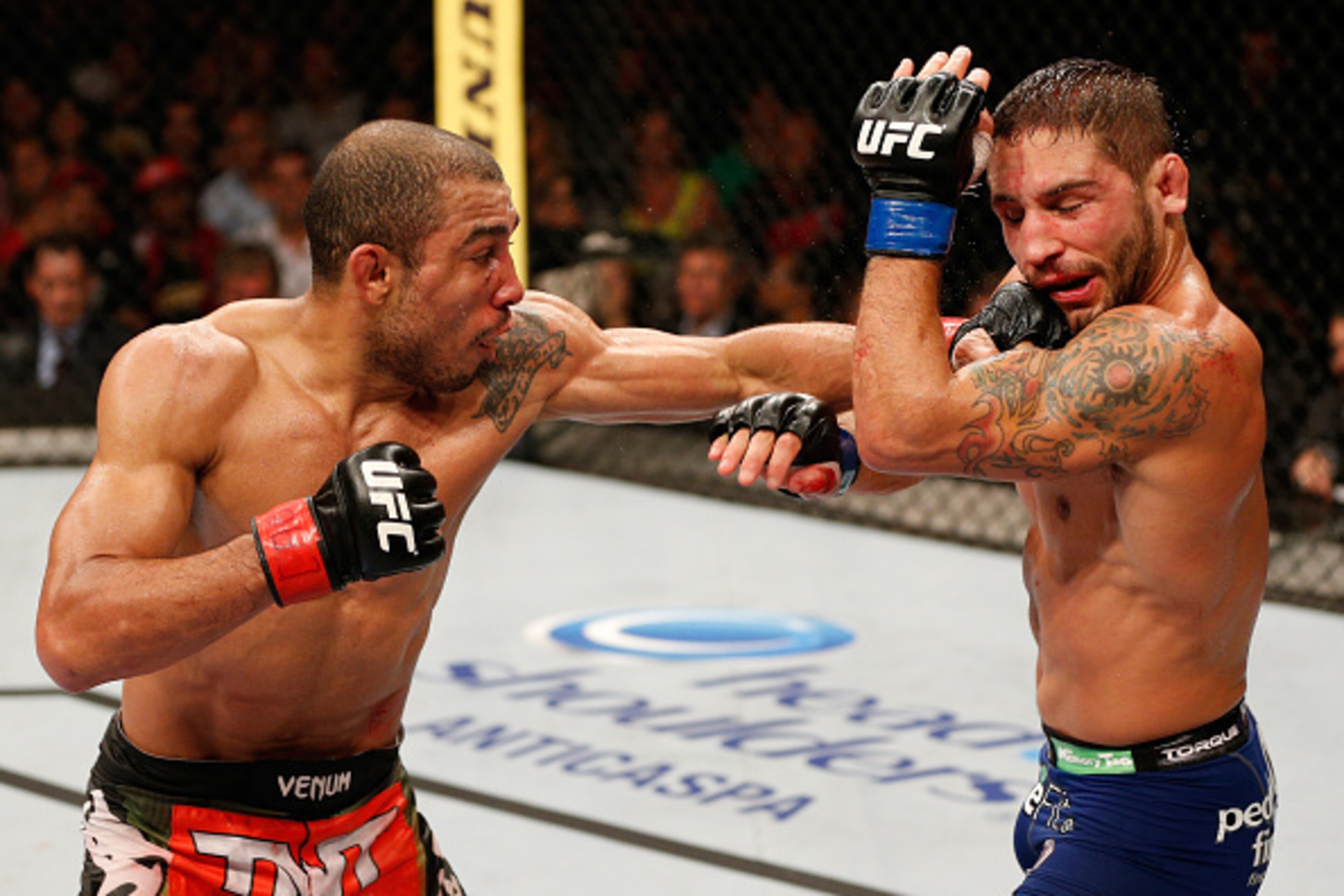 RIO DE JANEIRO, BRAZIL - OCTOBER 25:  (L-R) Jose Aldo of Brazil punches Chad Mendes in their featherweight championship bout during the UFC 179 event at Maracanazinho on October 25, 2014 in Rio de Janeiro, Brazil.  (Photo by Josh Hedges/Zuffa LLC/Zuffa LL