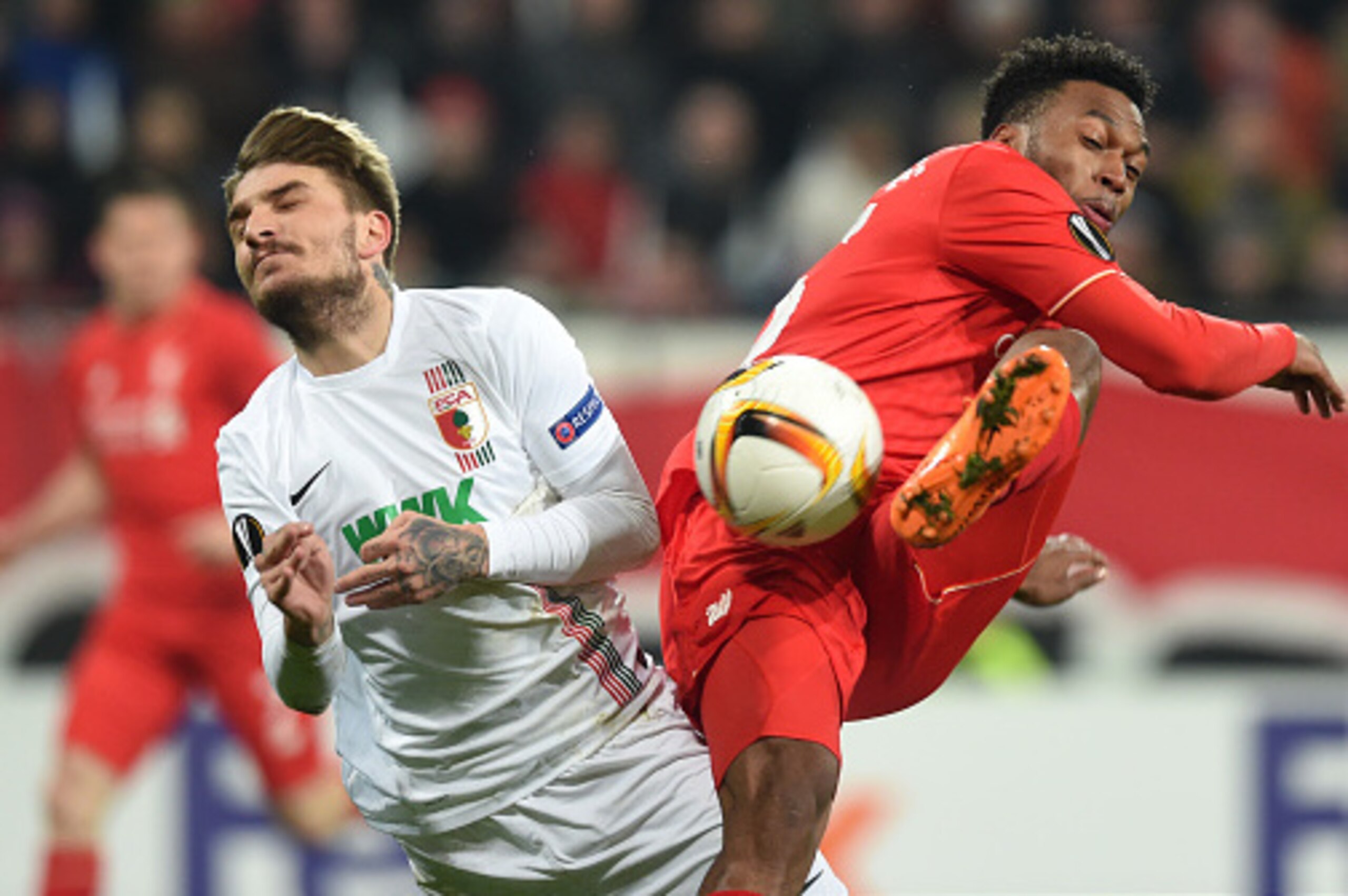 Augsburg's Greece defender Konstantinos Stafylidis (L) and Liverpool's striker Daniel Sturridge (R) vie for the ball during the UEFA Europa League Round of 32 football match between FC Augsburg and Liverpool FC in Augsburg, southern Germany on February 18
