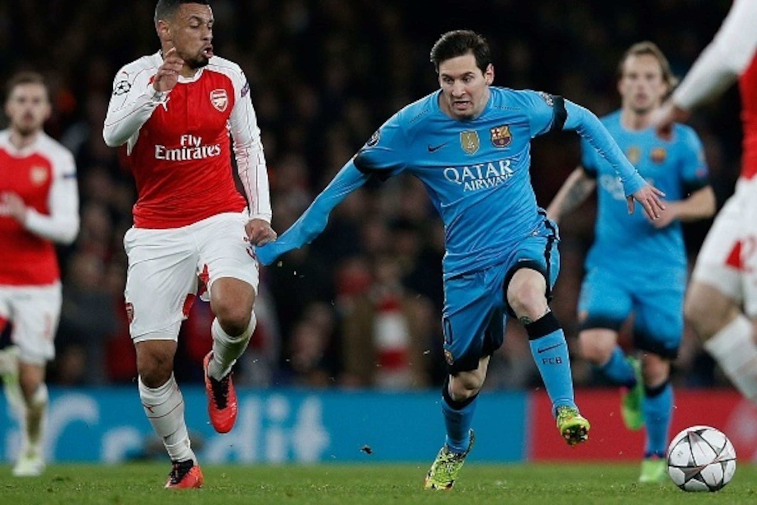 Arsenal's French midfielder Francis Coquelin (L) vies with Barcelona's Argentinian forward Lionel Messi during the UEFA Champions League round of 16 1st leg football match between Arsenal and Barcelona at the Emirates Stadium in London on February 23, 201