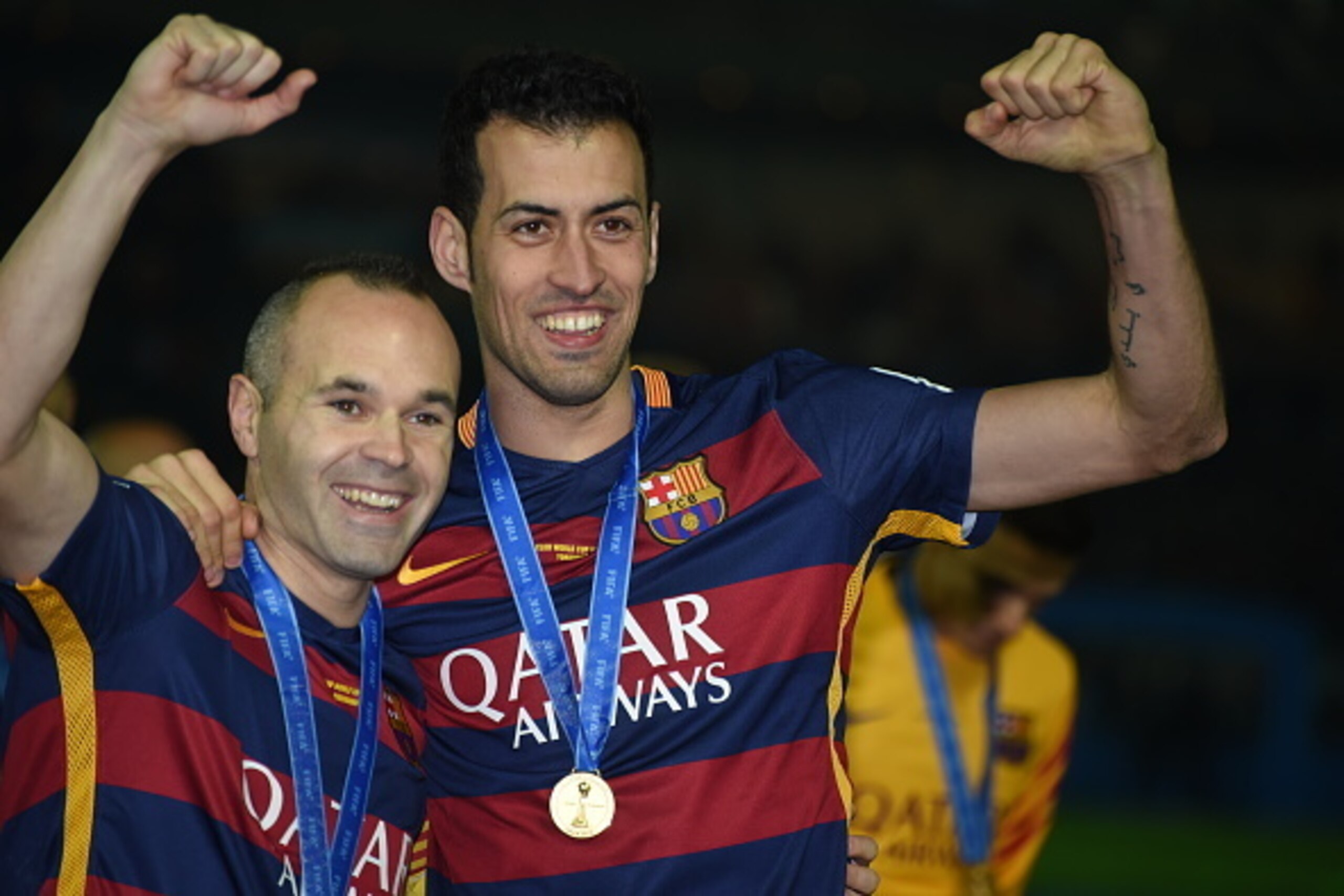 YOKOHAMA, JAPAN - DECEMBER 20:  Andres Iniesta and Sergio Busquets of FC Barcelona celebrate their win over River Plate during the FIFA Club World Cup Final match between River Plate and FC Barceloan at International Stadium Yokohama on December 20, 2015 