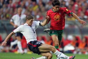 LISBON, Portugal:  Portugal's midfielder Deco (R) fights for the ball with England midfielder Steven Gerrard, 24 June 2004 during their European Nations Championship quarter-final football match between Portugal and England at the Estadio Da Luz in Lisbon