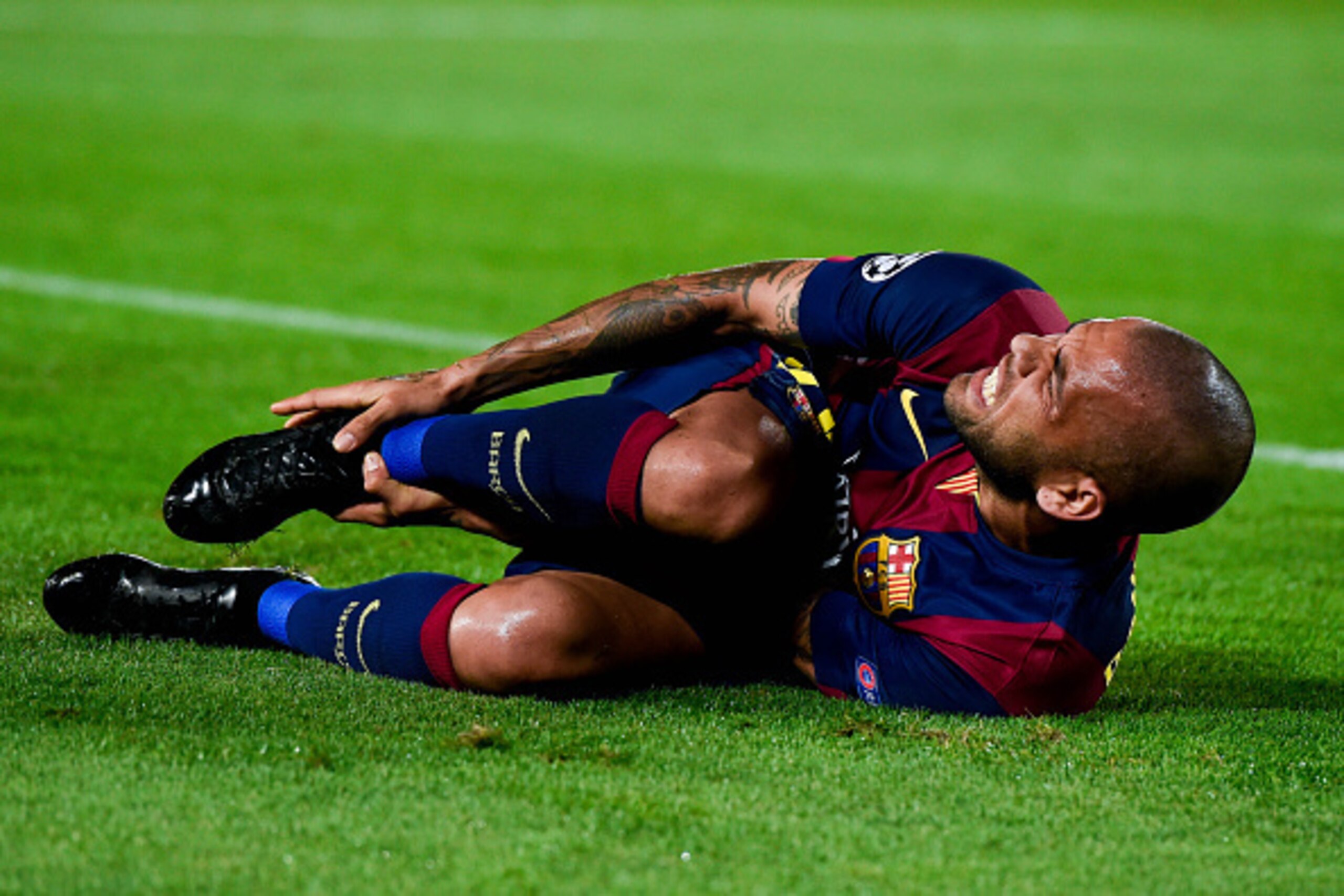 BARCELONA, SPAIN - OCTOBER 21:  Dani Alves of FC Barcelona reacts on the pitch during a UEFA Champions League Group F match between FC Barcelona and AFC Ajax at the Camp Nou Stadium on October 21, 2014 in Barcelona, Spain.  (Photo by David Ramos/Getty Ima