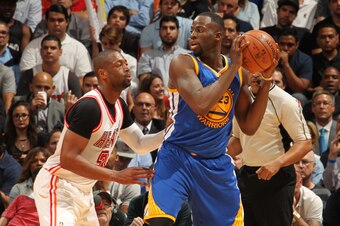 MIAMI, FL - FEBRUARY 24:  Draymond Green #23 of the Golden State Warriors handles the ball against Dwyane Wade #3 of the Miami Heat on February 24, 2016 at American Airlines Arena in Miami, Florida. NOTE TO USER: User expressly acknowledges and agrees tha