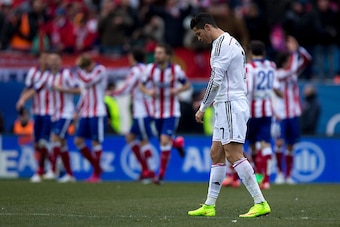 MADRID, SPAIN - FEBRUARY 07:  Cristiano Ronaldo of Real Madrid CF reacts defeated as behind Mario Mandzukic of Atletico de Madrid celebrates scoring their fourth goal with teammates during the La Liga match between Club Atletico de Madrid and Real Madrid 