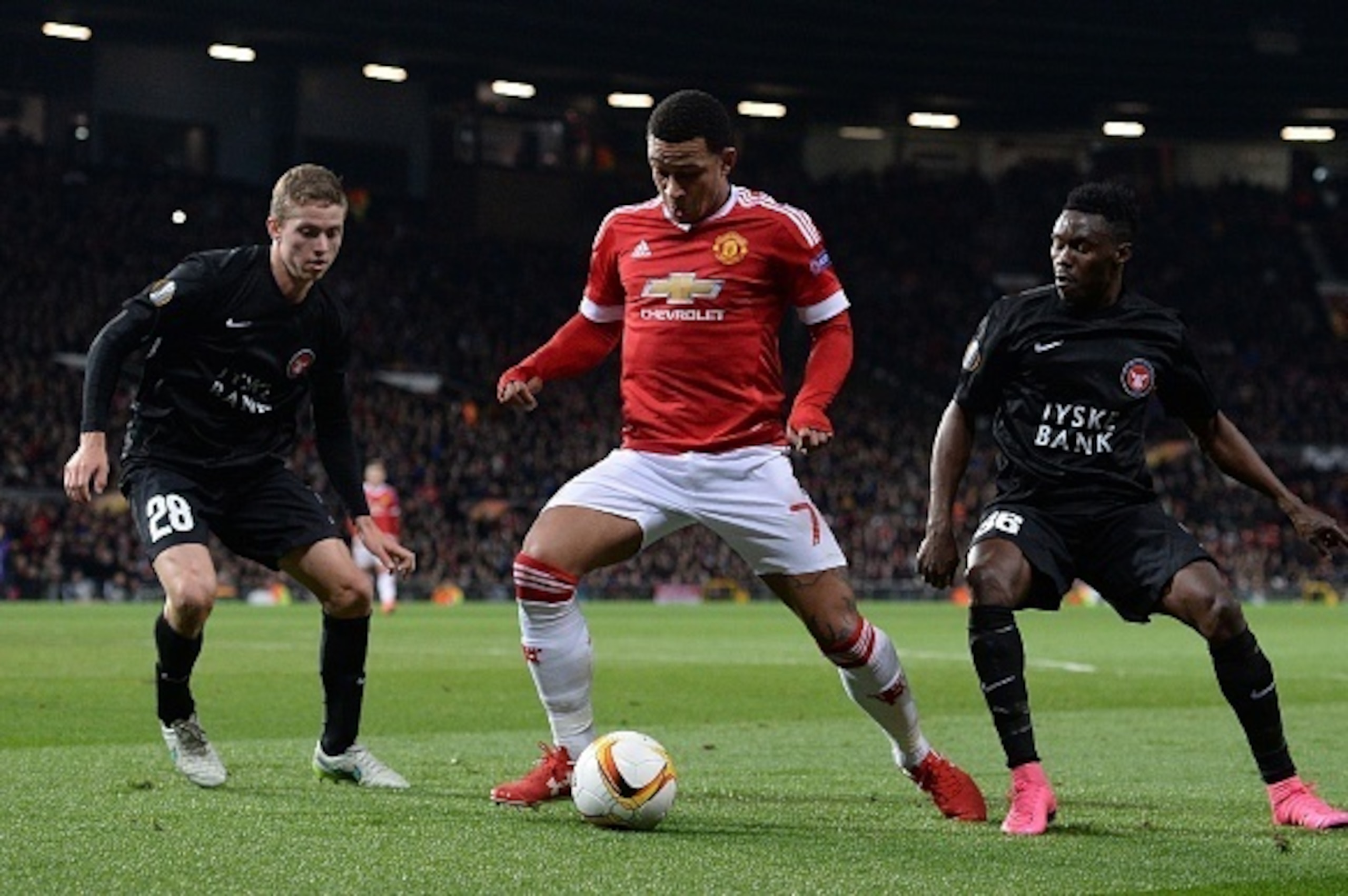 Manchester United's Dutch midfielder Memphis Depay (C) vies with FC Midtjylland's Danish midfielder Andre Romer (L) and FC Midtjylland's Nigerian midfielder Rilwan Hassan during the UEFA Europa League round of 32, second leg football match between Manches Manchester United's Dutch midfielder Memphis Depay (C) vies with FC Midtjylland's Danish midfielder Andre Romer (L) and FC Midtjylland's Nigerian midfielder Rilwan Hassan during the UEFA Europa League round of 32, second leg football match between Manches