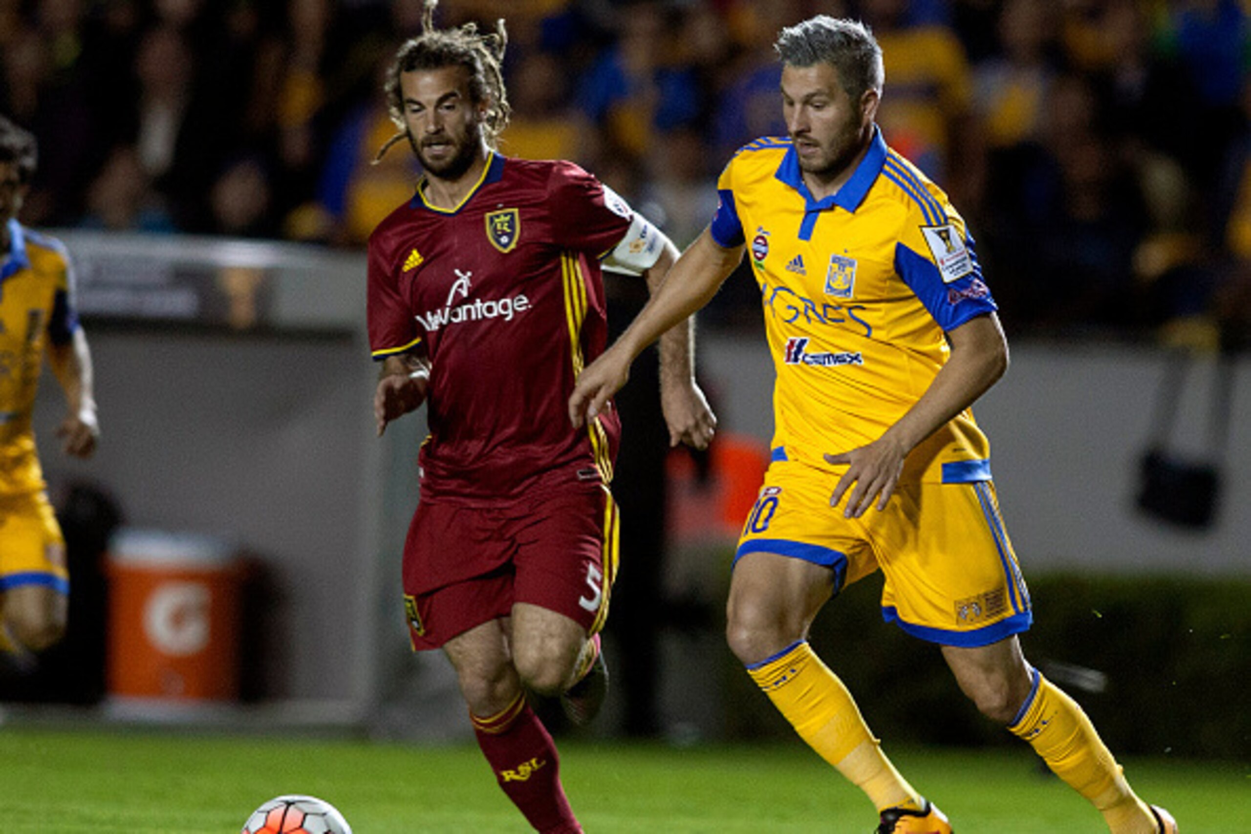 Andre Pierre Gignac  (R) of Mexican team Tigres vies for the ball with Kyle Beckerman (L) of US Real Salt Lake, during their Concacaf Champions League first leg quarterfinal football match in Monterrey, Mexico, on February 24, 2016.   AFP PHOTO/Julio Cesa