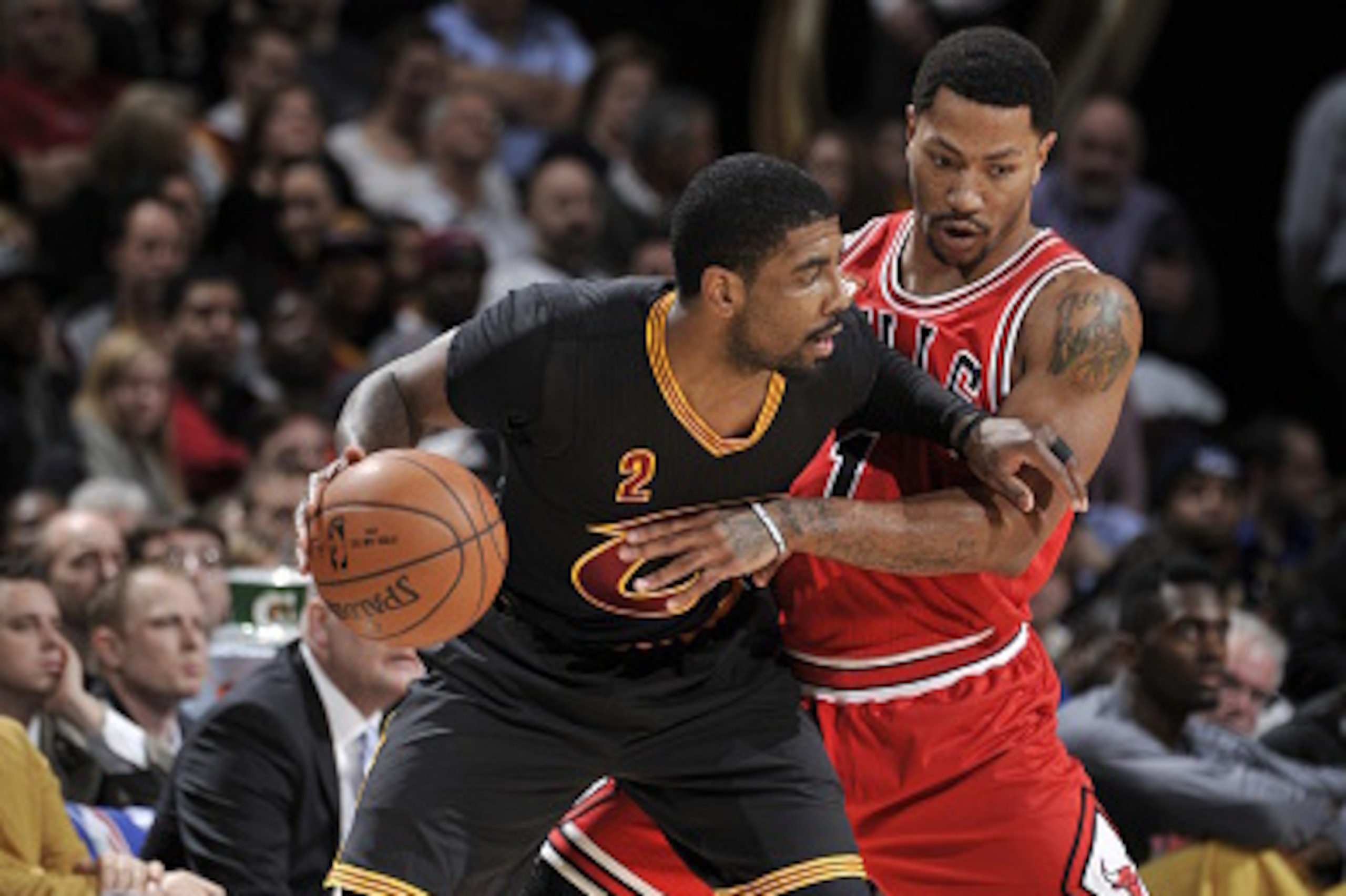 CLEVELAND, OH - FEBRUARY 18:  Kyrie Irving #2 of the Cleveland Cavaliers handles the ball against Derrick Rose #1 of the Chicago Bulls on February 18, 2016 at Quicken Loans Arena in Cleveland, Ohio. NOTE TO USER: User expressly acknowledges and agrees tha