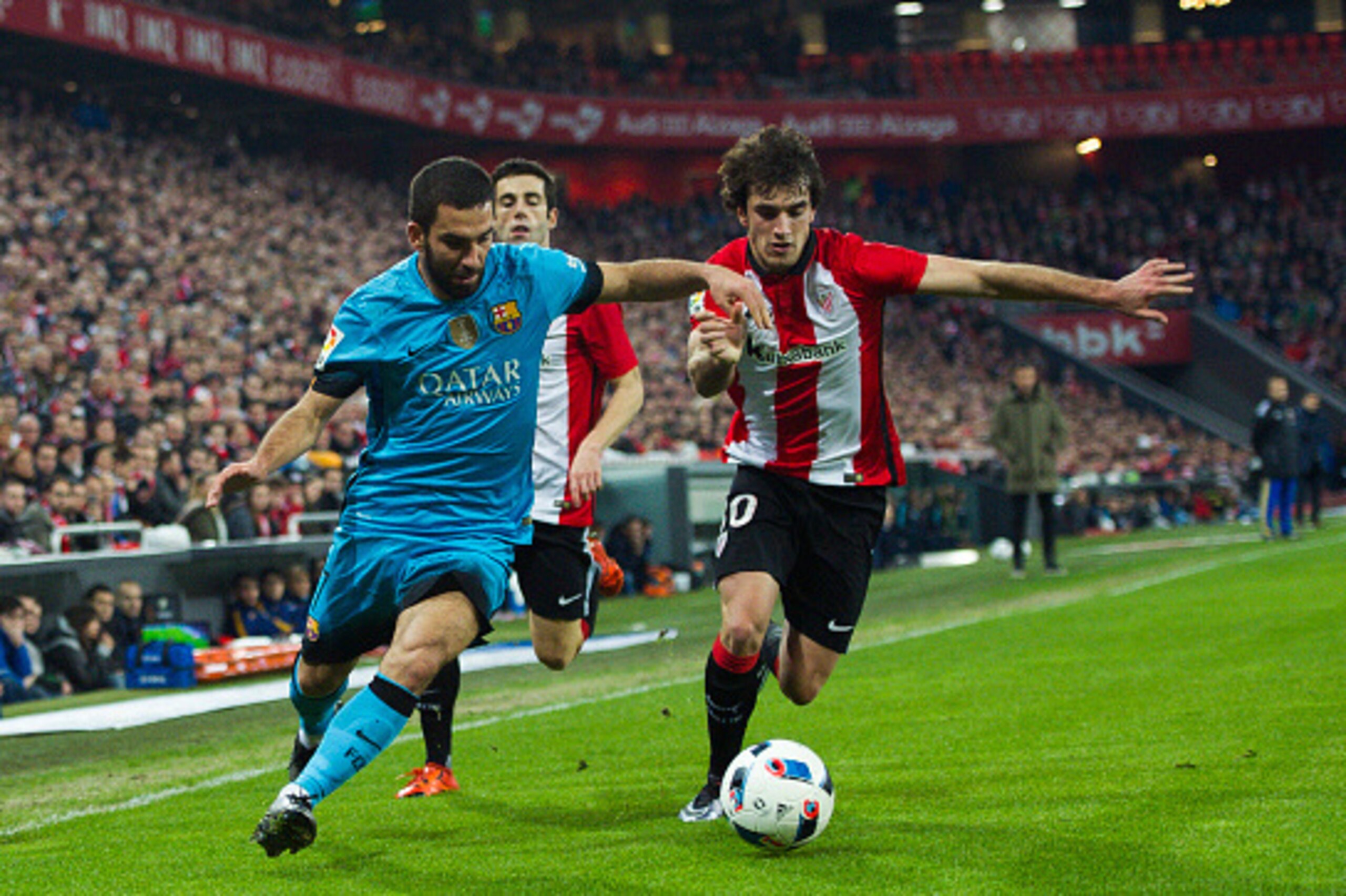 BILBAO, SPAIN - JANUARY 20:  Arda Turan of FC Barcelola duels for the ball with Inigo Lekue of Athletic Club during the Copa del Rey Quarter Final First Leg match between Athletic Club and FC Barcelola at San Mames Stadium on January 20, 2016 in Bilbao, S
