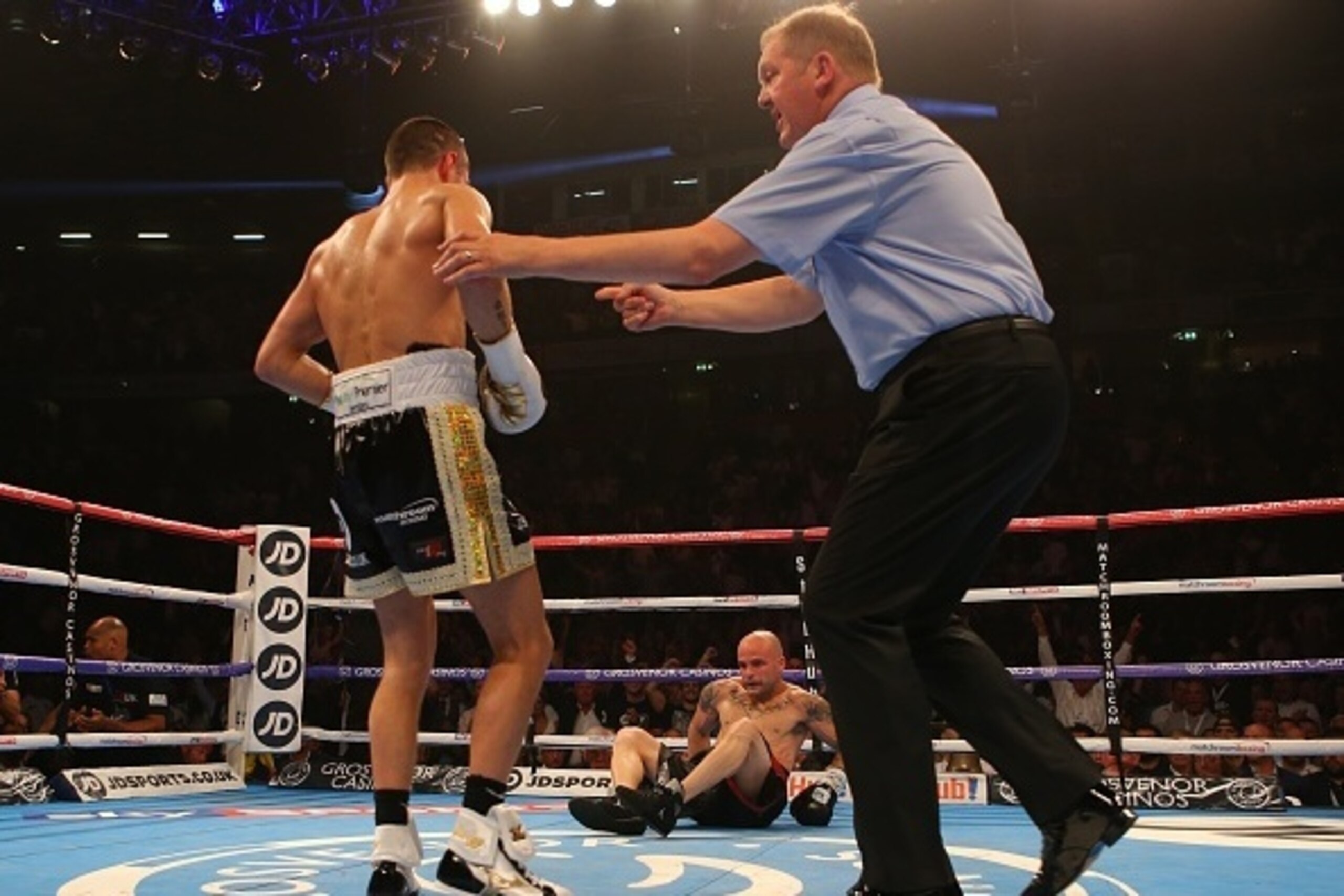 MANCHESTER, ENGLAND - JULY 18: Scott Quigg knocks down Kiko Martinez for the first time during their WBA World Super Bantamweight Championship contest at the Manchester Arena on July 18, 2015 in Manchester, England. (Photo by Dave Thompson/Getty Images)